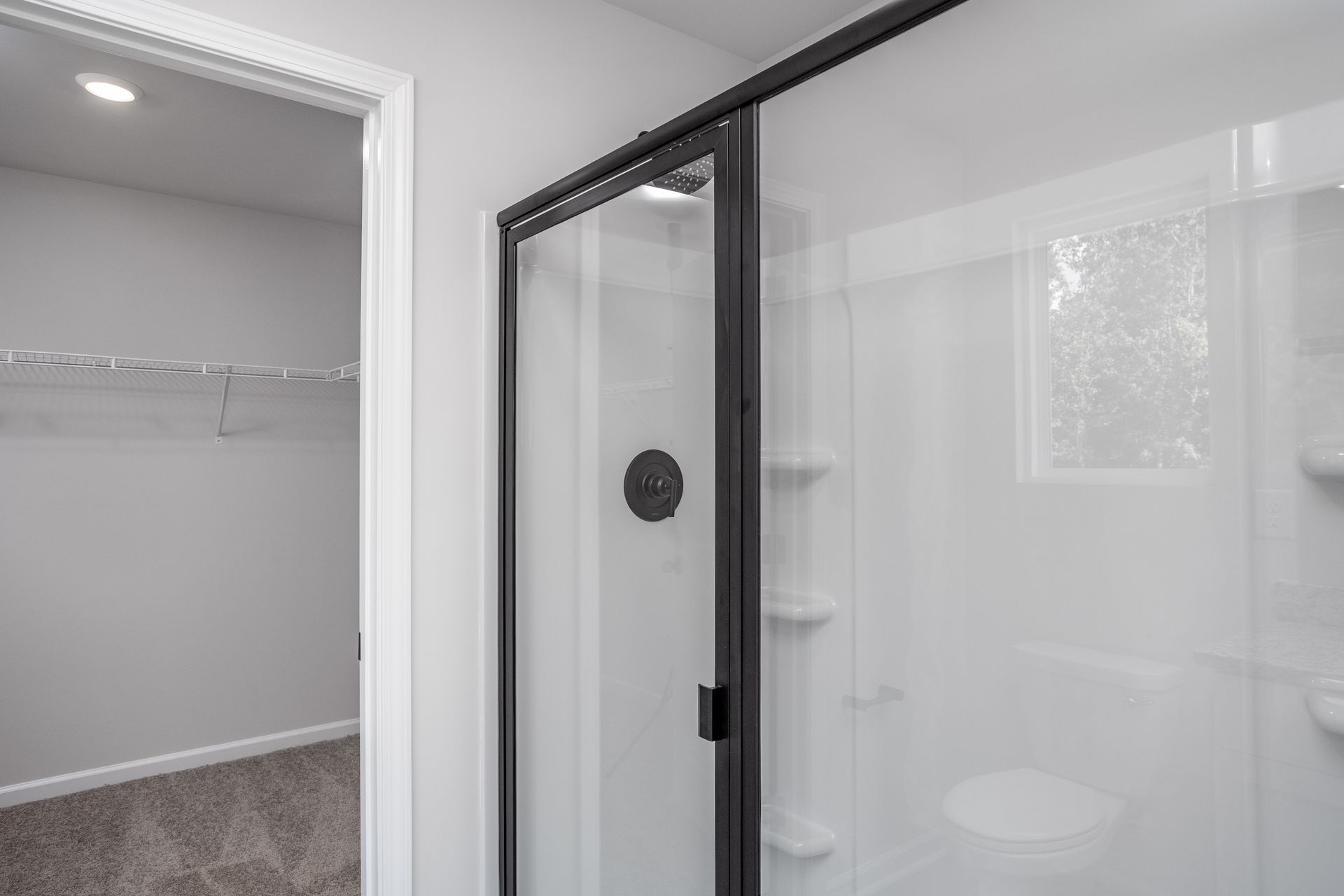 This bathroom has a glass-enclosed shower