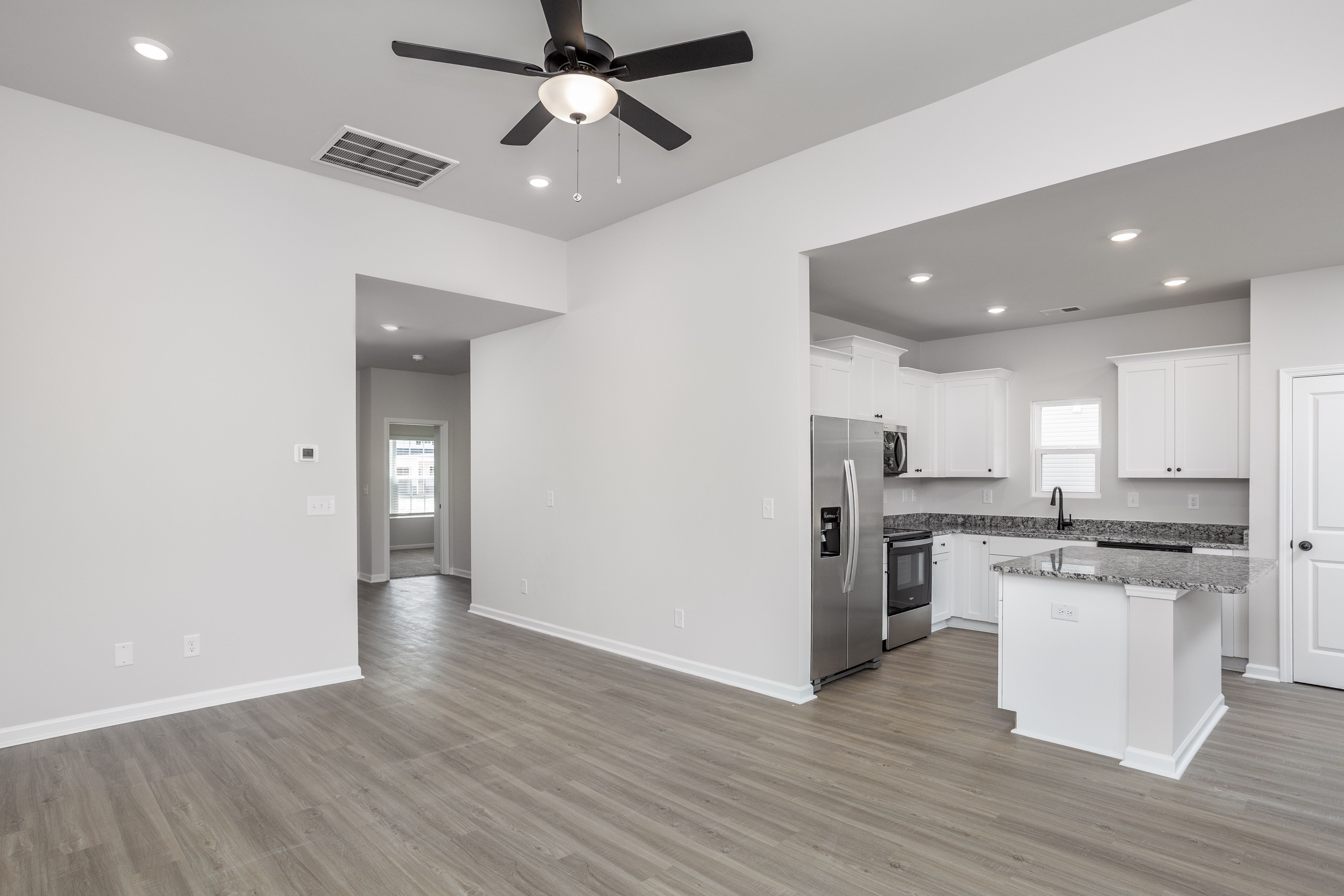 Living room has vinyl plank flooring
