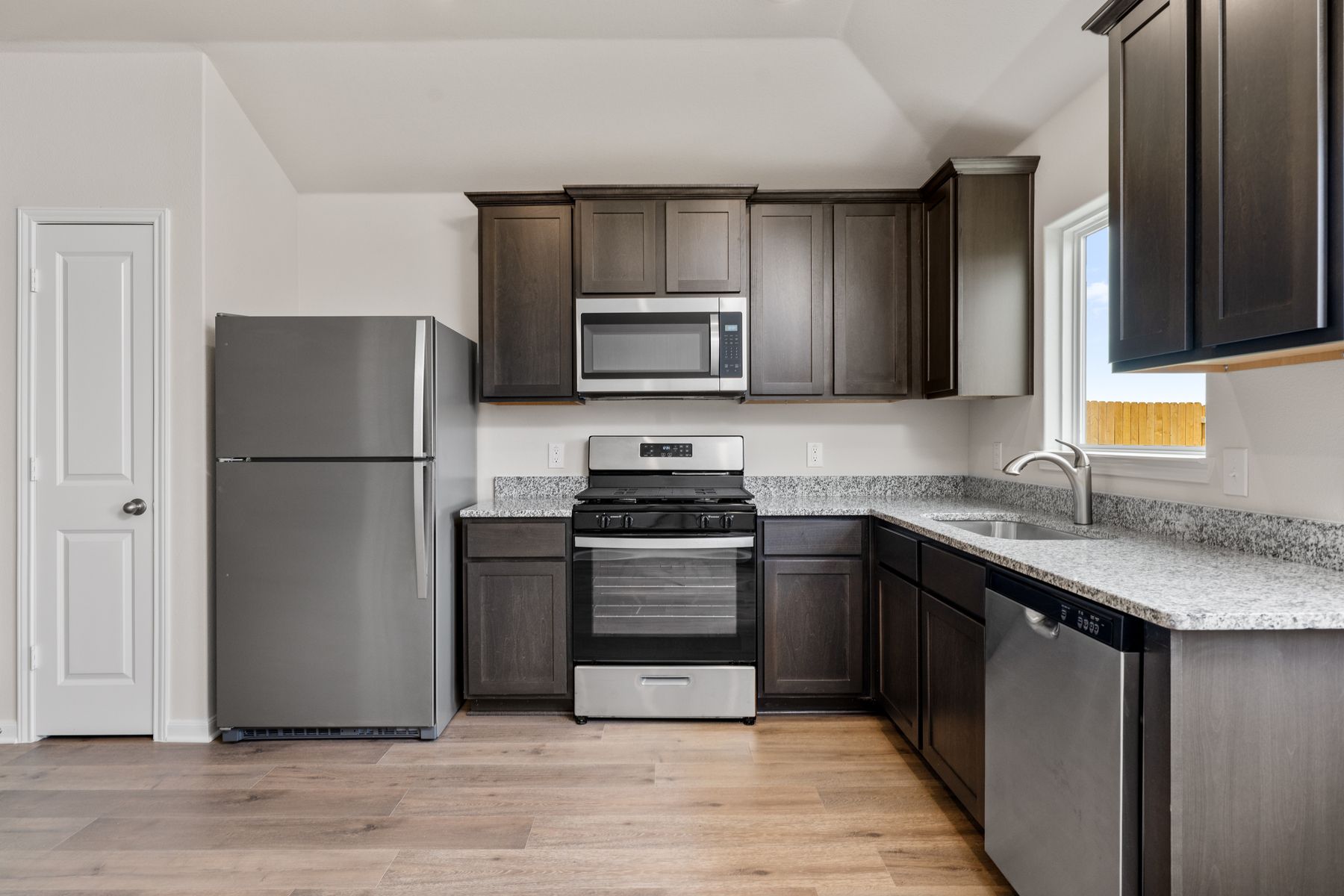 The kitchen has sprawling granite countertops.
