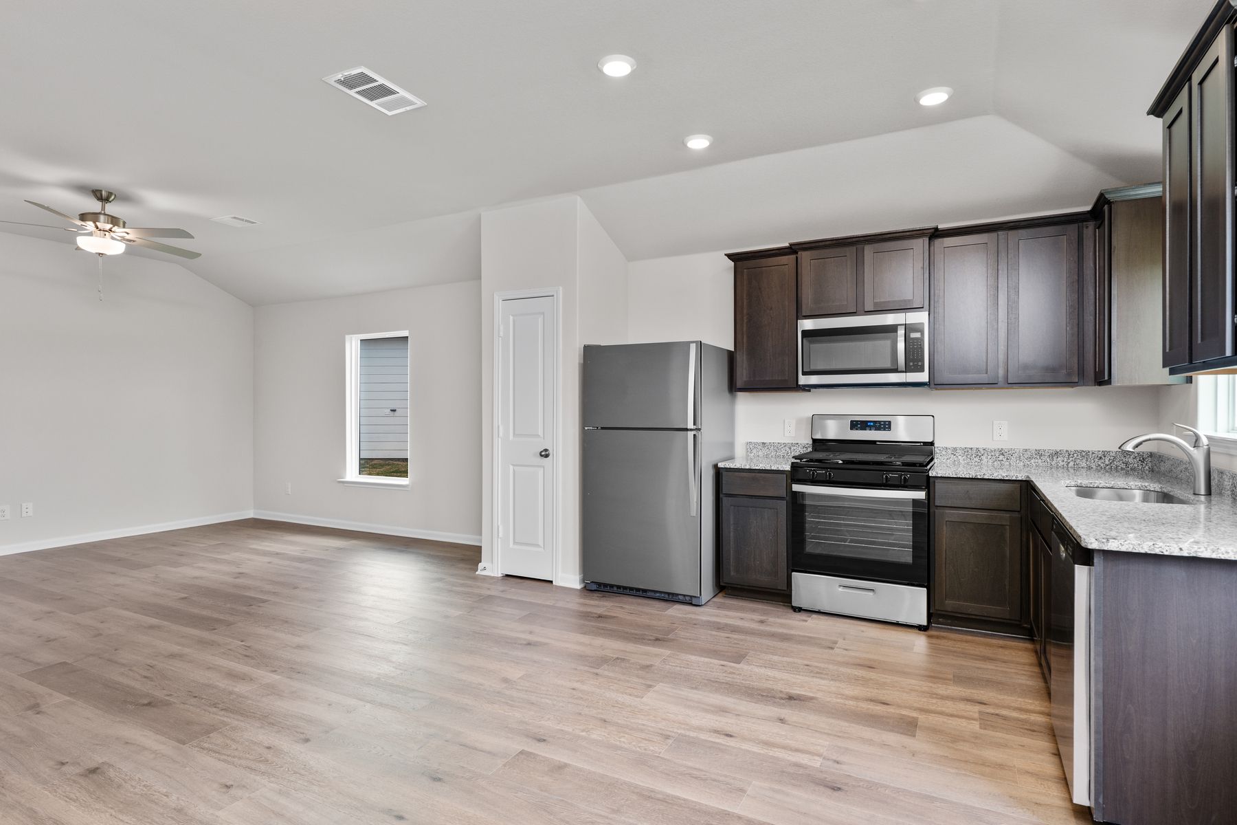 The kitchen has designer wood cabinetry.