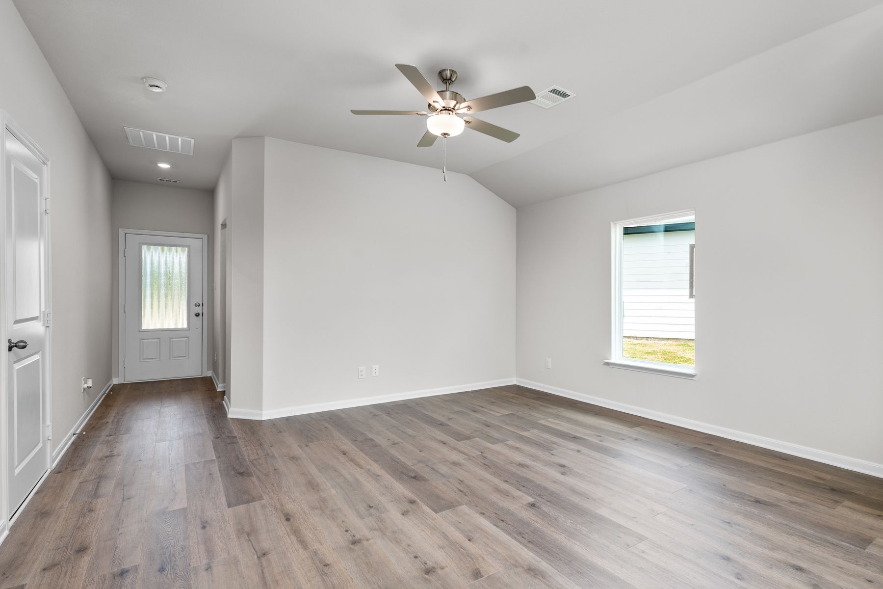 The living room is spacious and has plenty of space for furniture.
