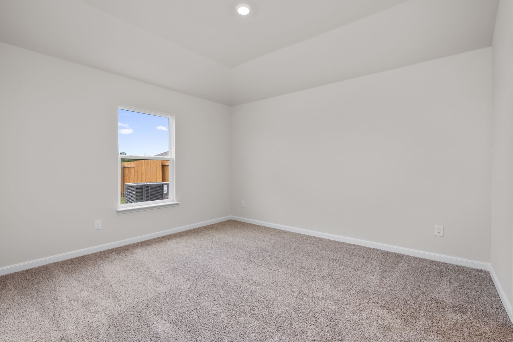 The master bedroom is spacious and has a large window.