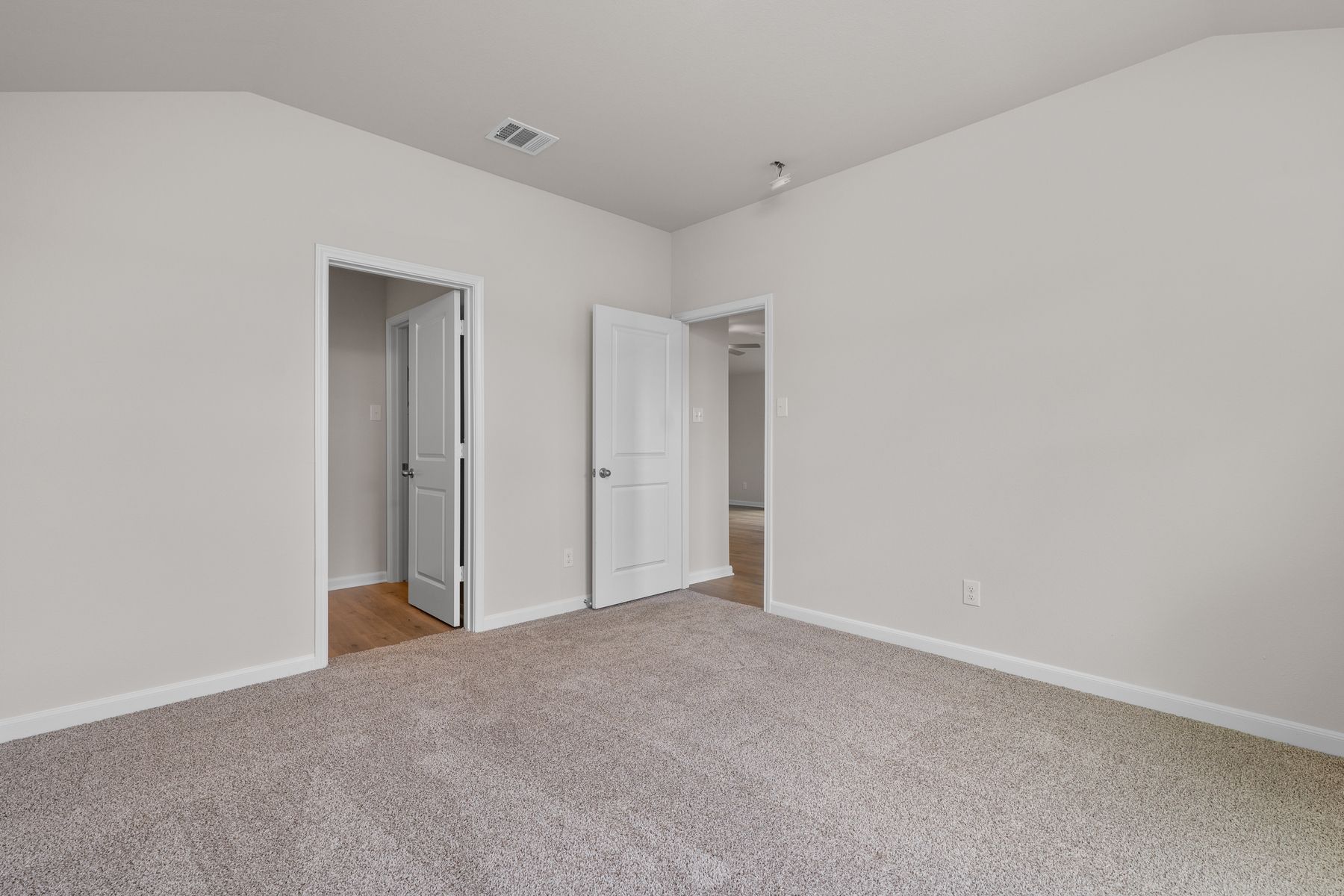 The master suite has a large bedroom, ensuite bathroom and a walk-in closet.
