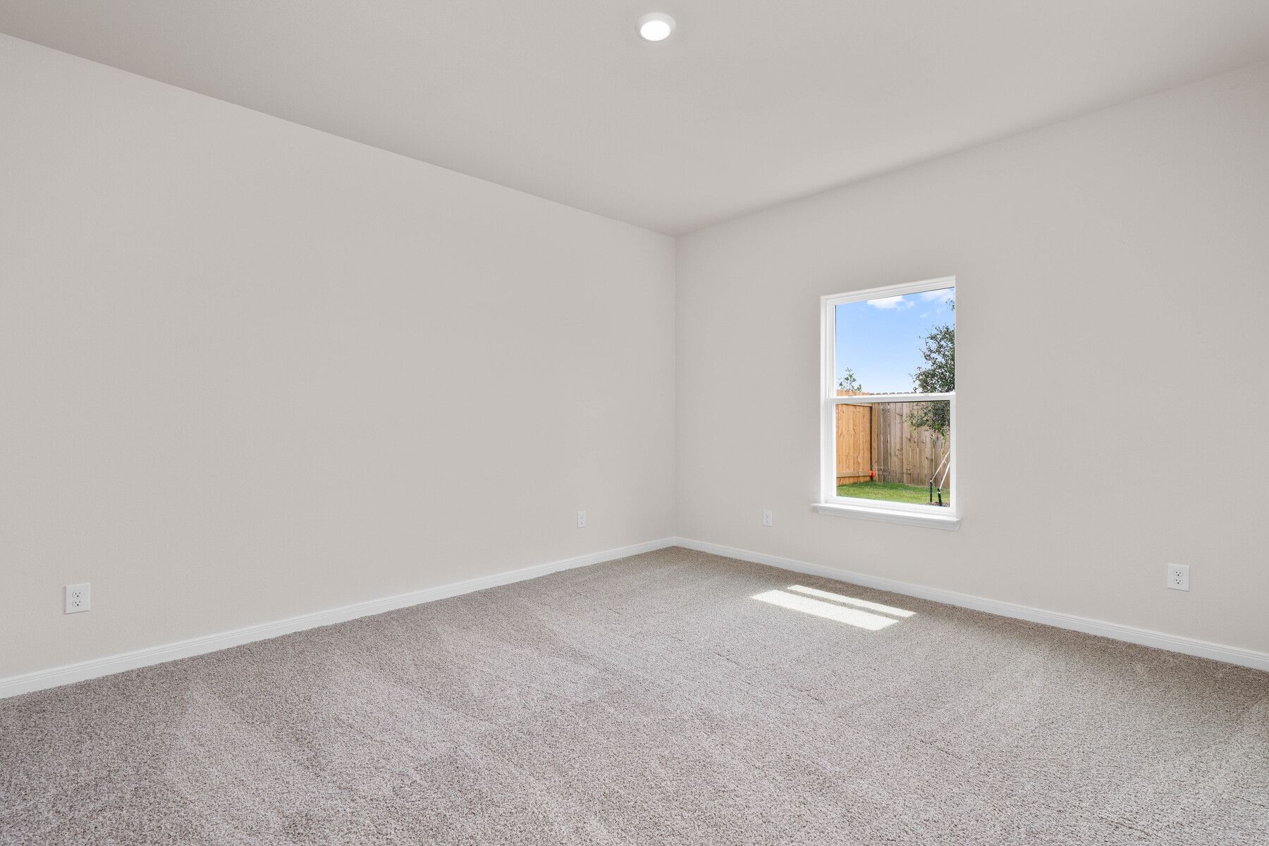 The master bedroom is spacious and has a large window.