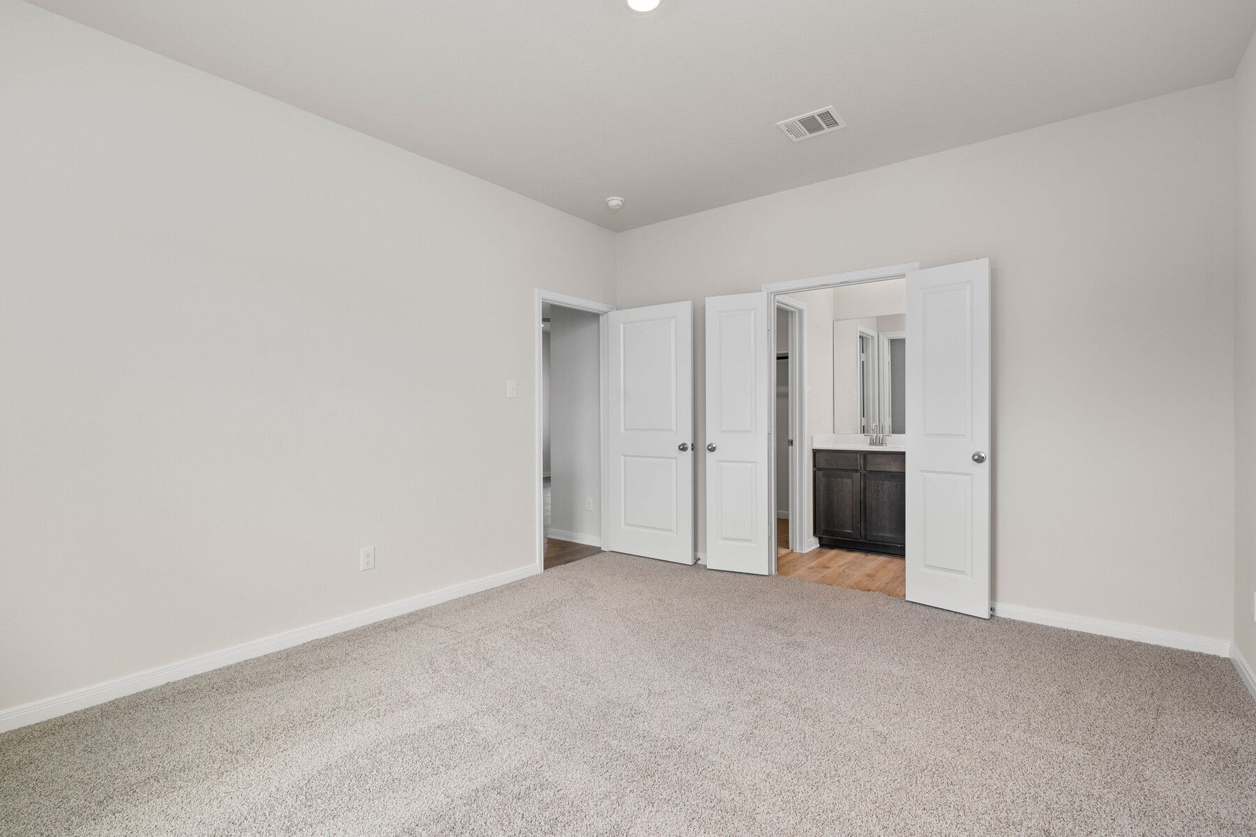 The master suite has a large bedroom, ensuite bathroom and a walk-in closet.