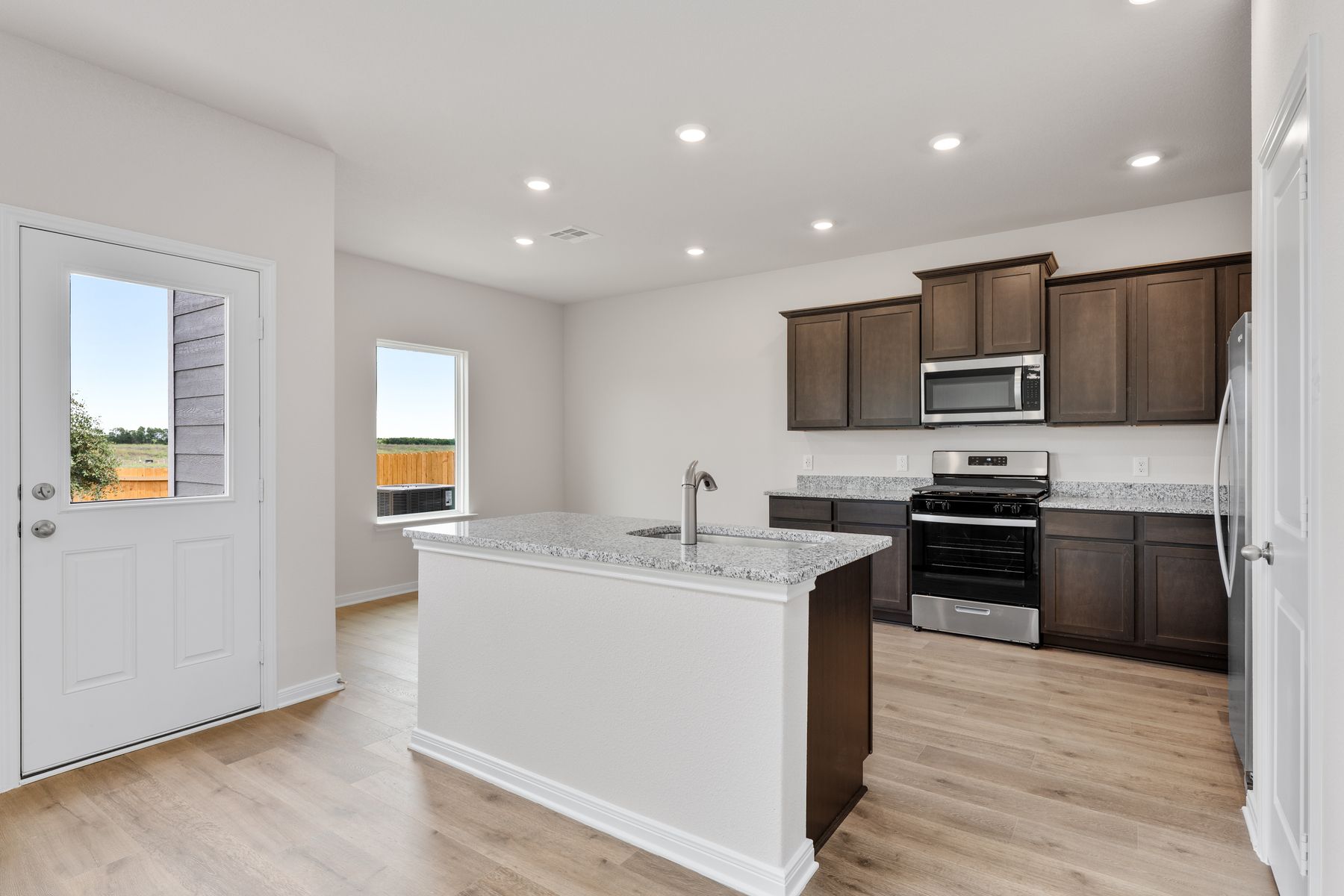 The kitchen has designer wood cabinetry.
