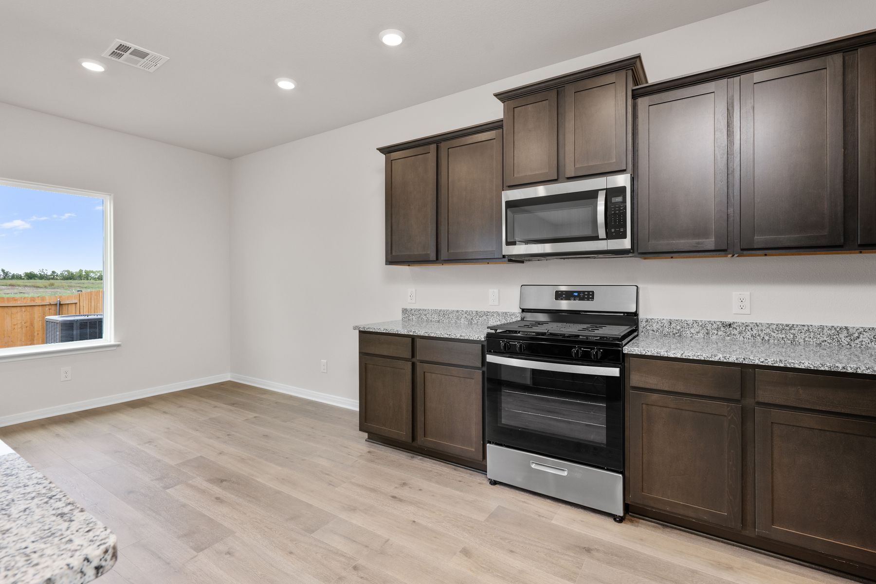 The kitchen has sprawling granite countertops.