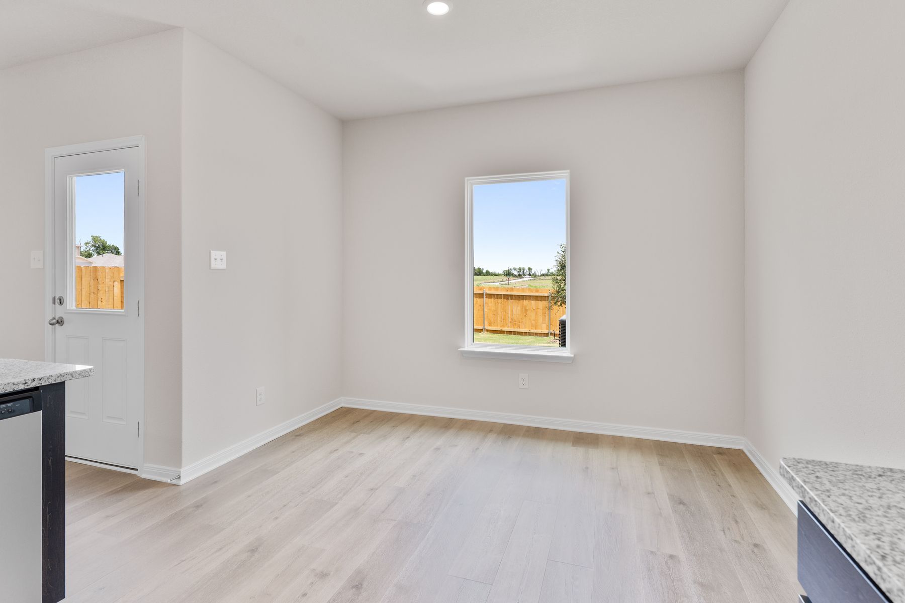 The dining room has a large window that lets in great, natural light and backyard views.