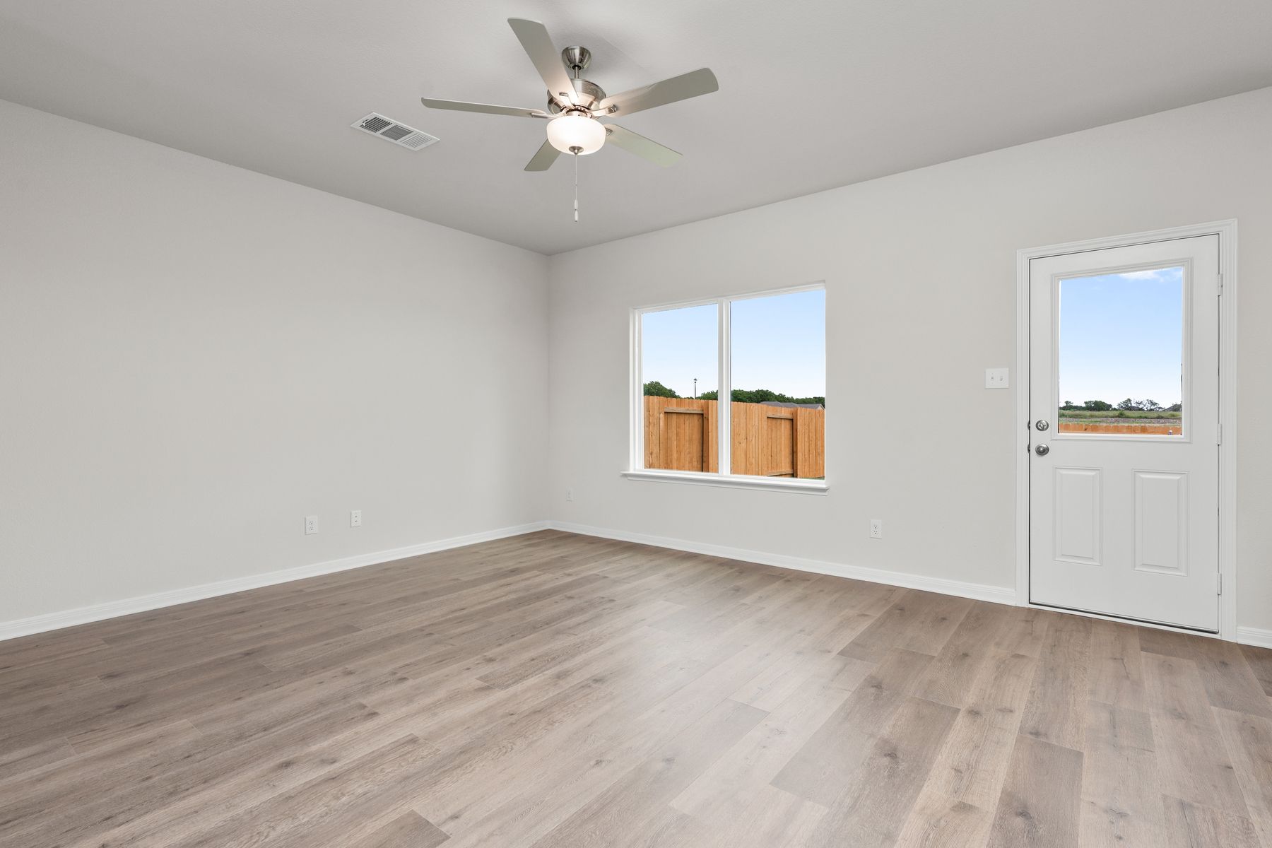 The large living room has a window that lets in great, natural light and backyard views.