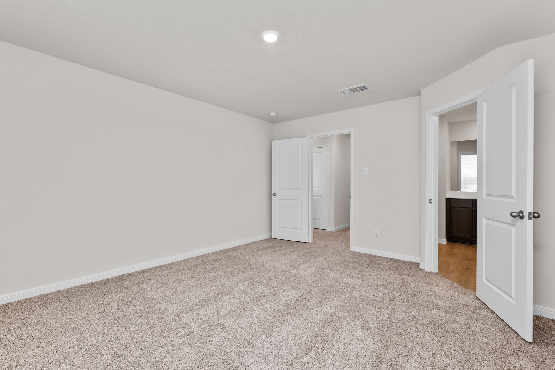The master suite has a large bedroom, ensuite bathroom and a walk-in closet.
