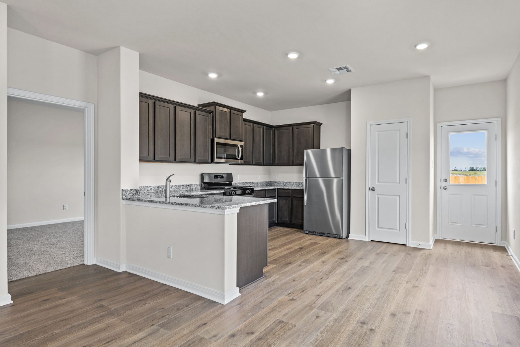 The kitchen has designer wood cabinetry.