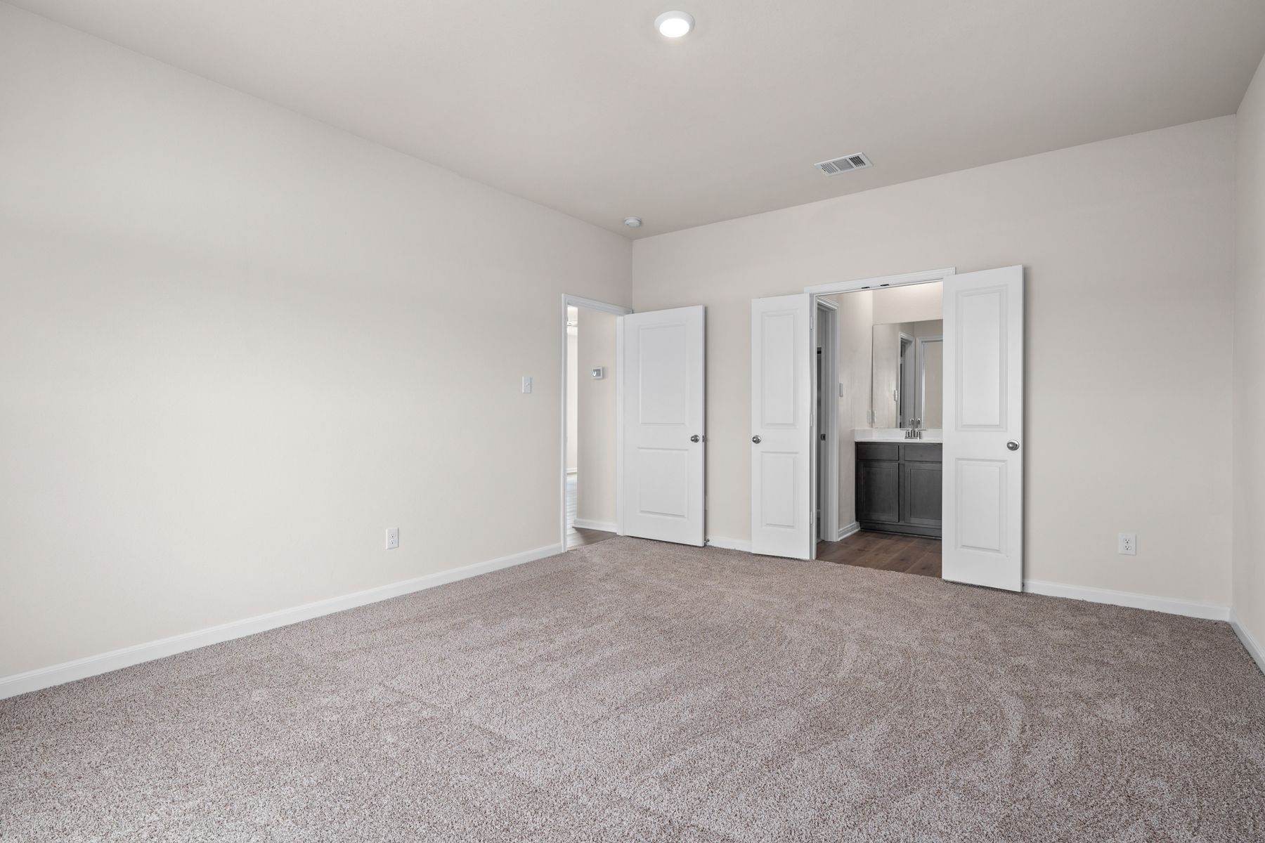 The master suite has a large bedroom, ensuite bathroom and a walk-in closet.