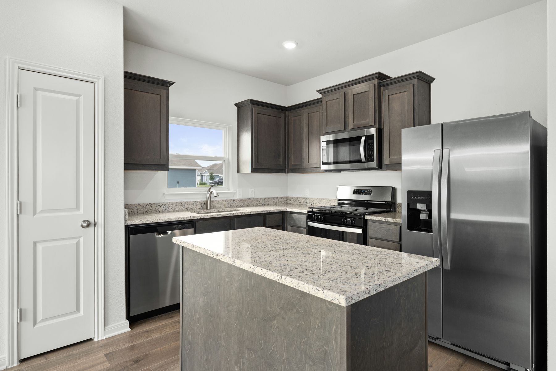 The kitchen has sprawling granite countertops.