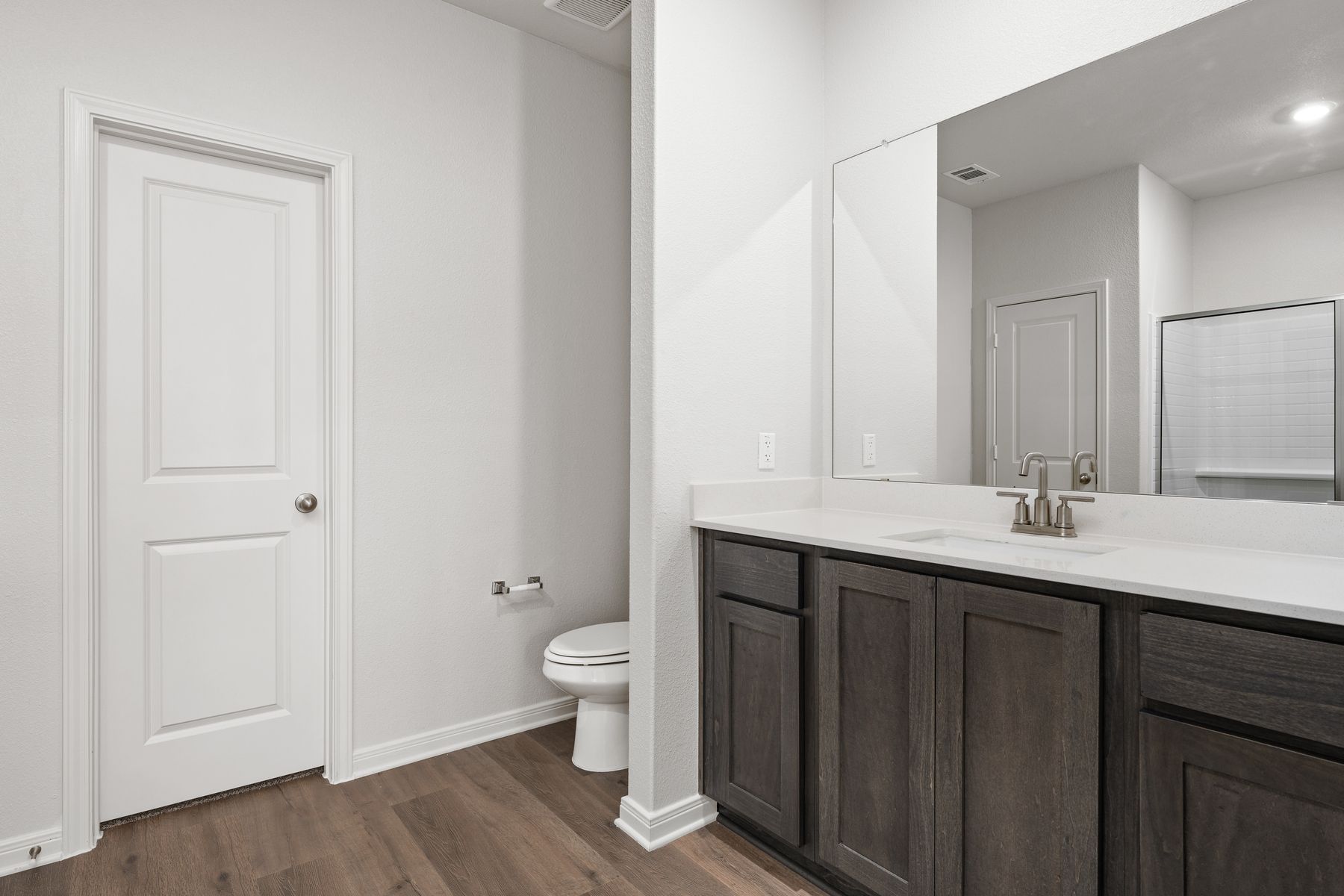 The master bathroom has a sprawling vanity.