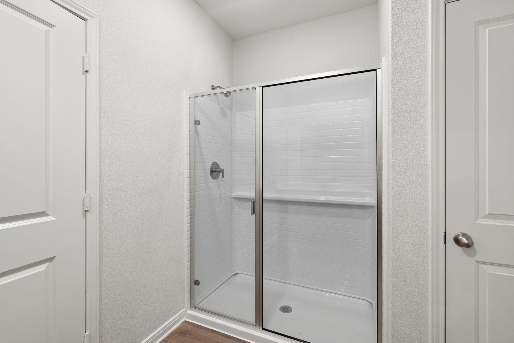 The master bathroom has a glass, walk-in shower.