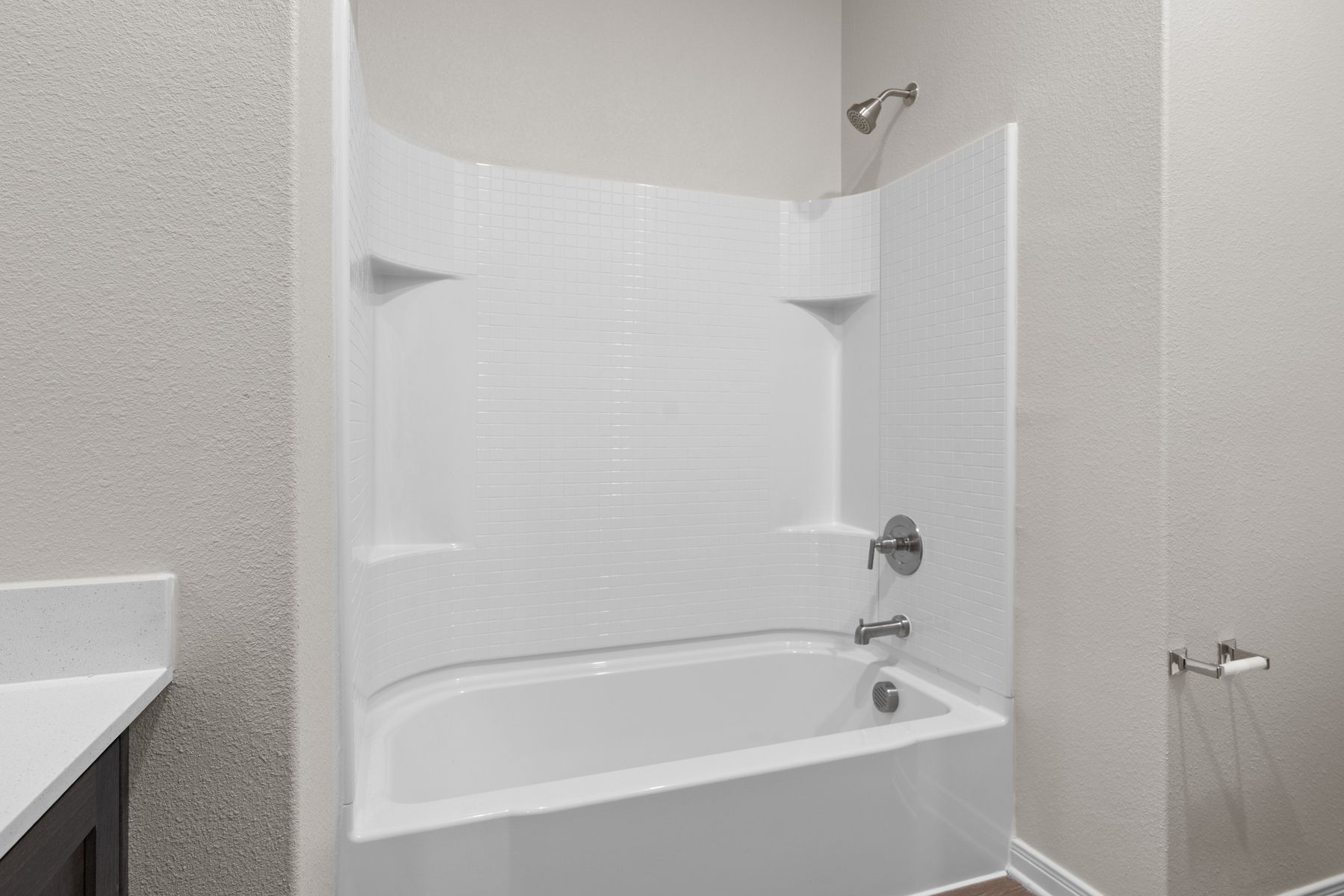 The secondary bathroom has a shower-tub combo.