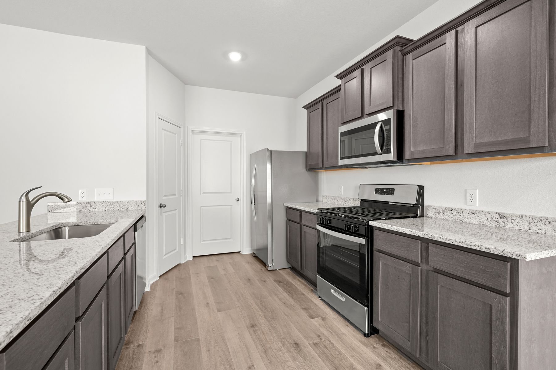 The kitchen of the Cypress has gorgeous wood cabinetry.