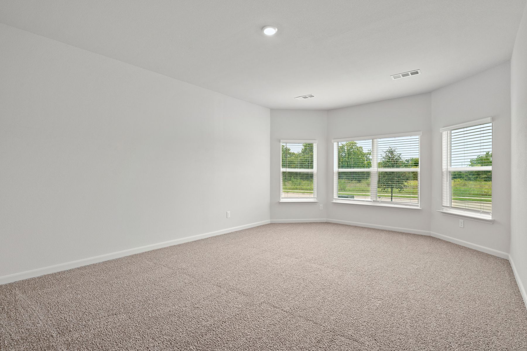 The master bedroom has large windows.