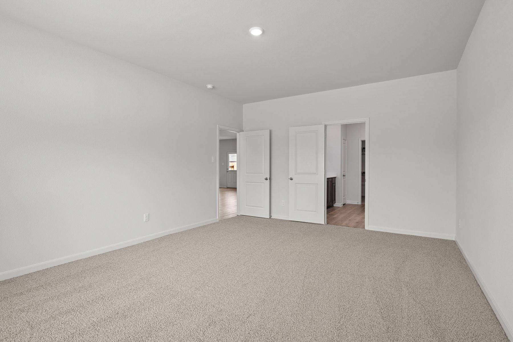 The master suite has a large bedroom, ensuite bathroom and a walk-in closet.