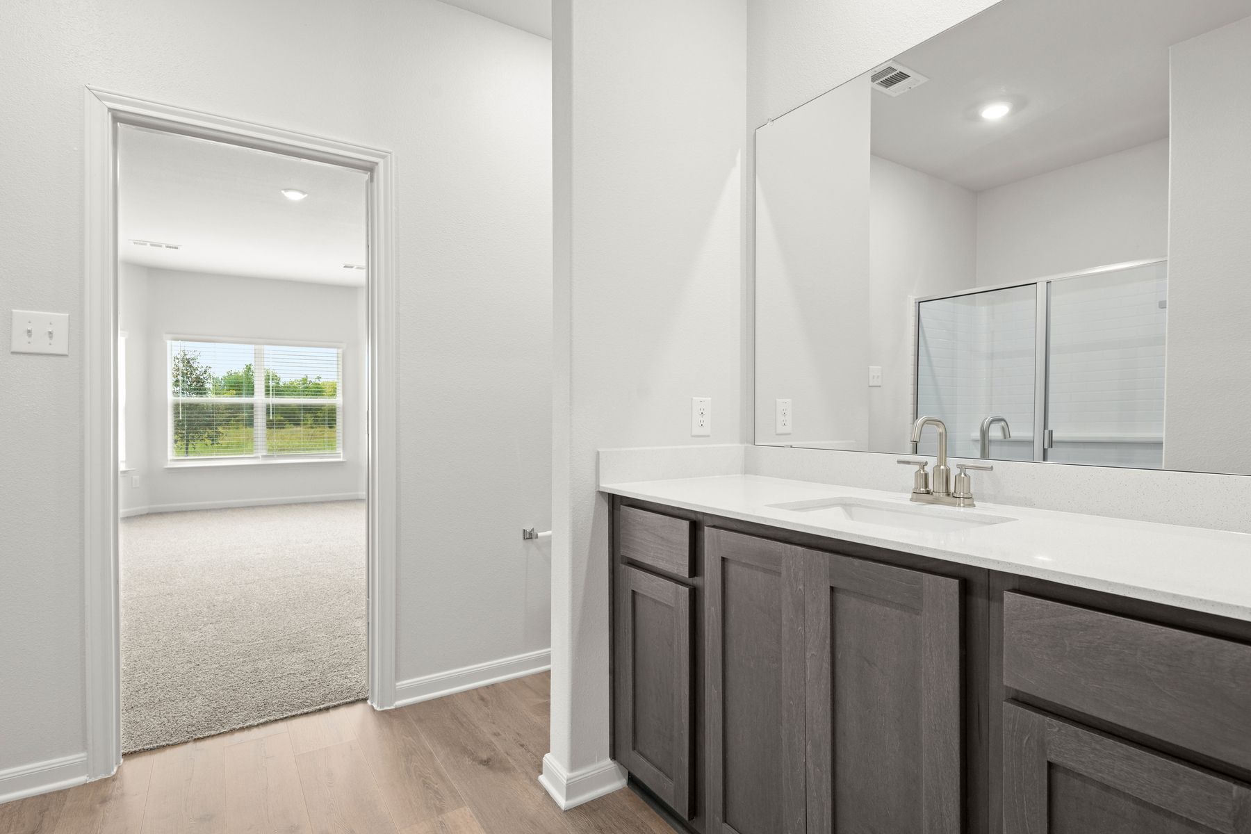 The master bathroom has a large vanity space.