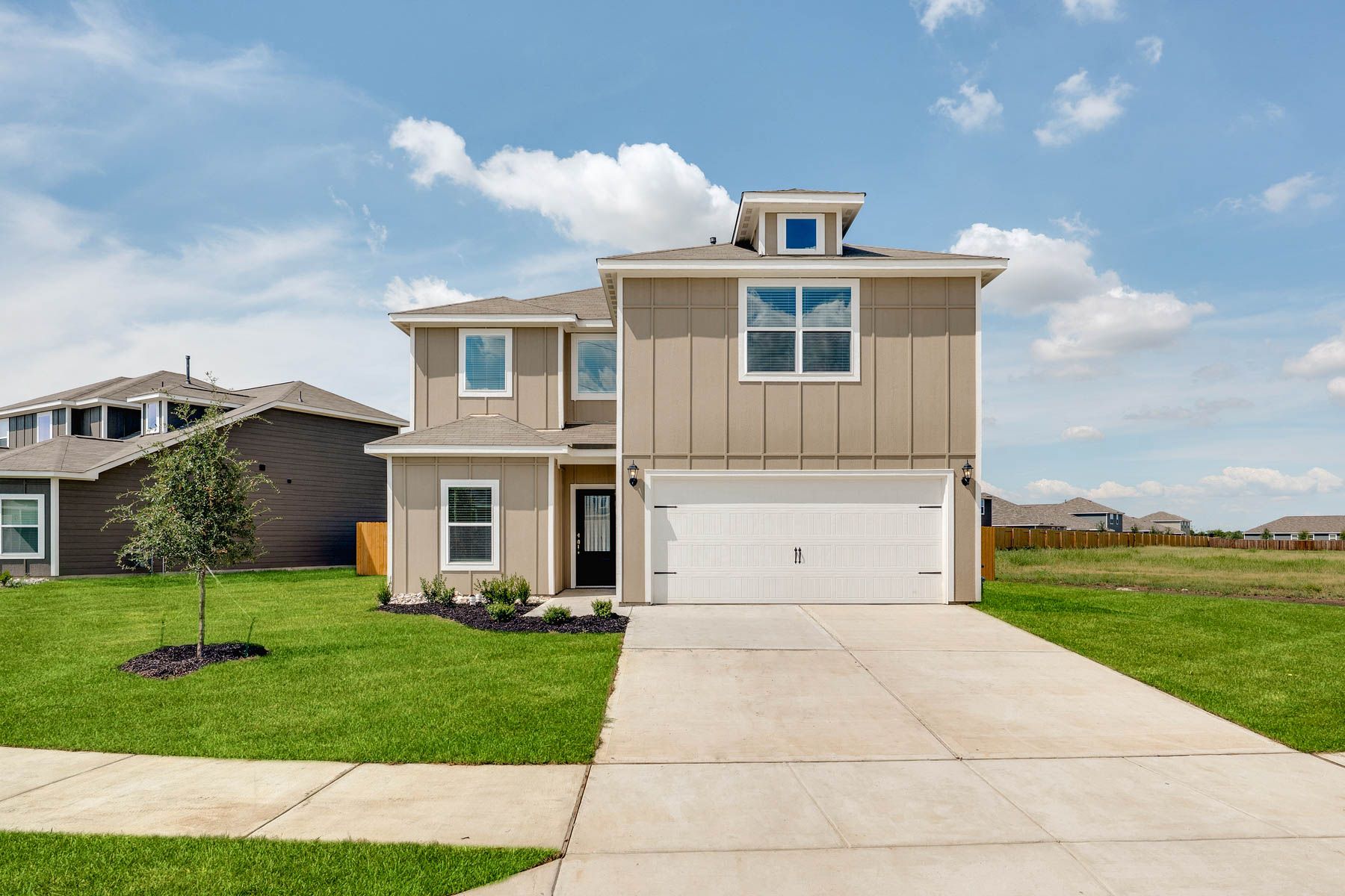 The two-story Driftwood plan is a beautiful siding home.