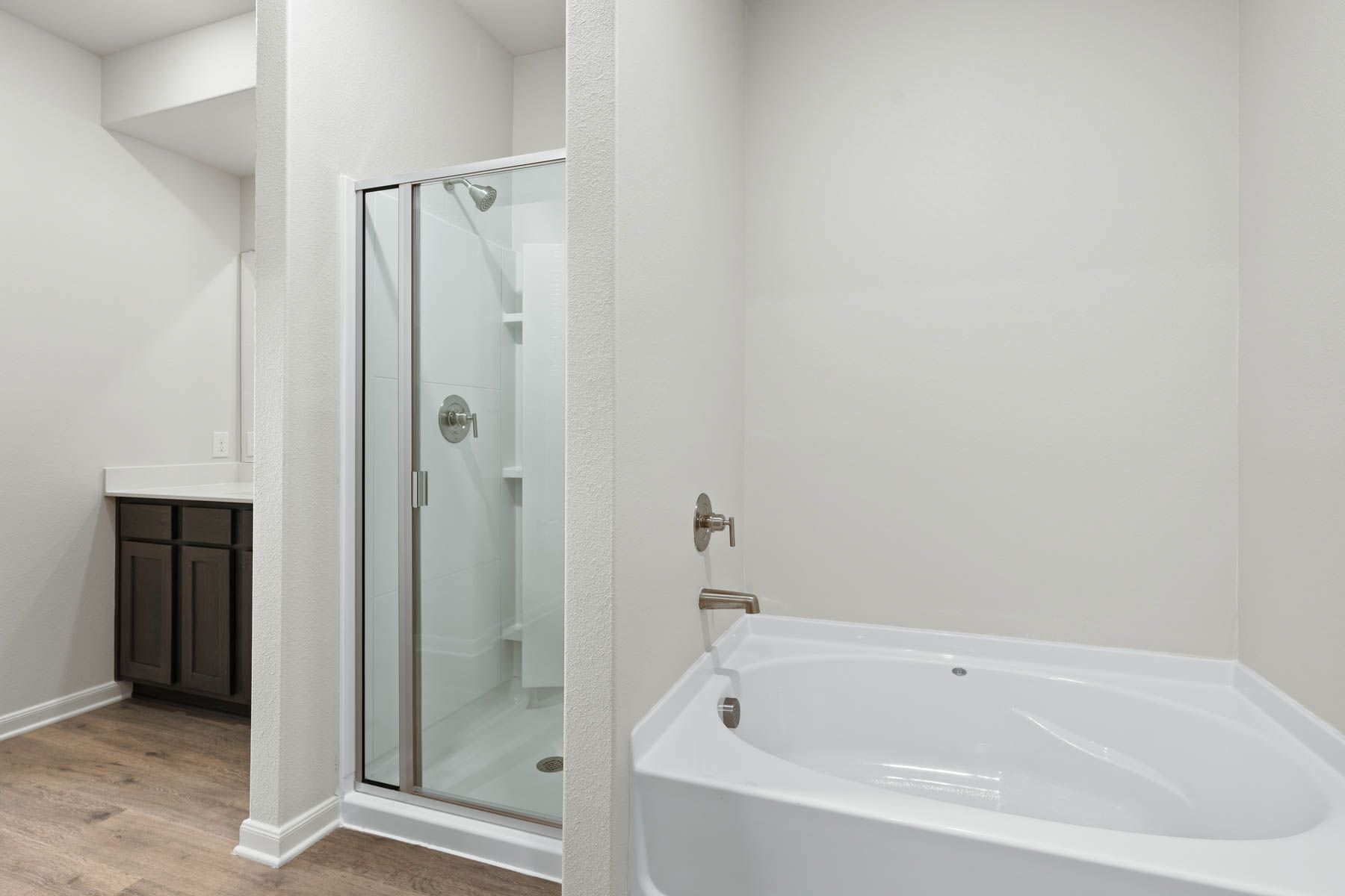The master bathroom has a glass, walk-in shower and a garden tub.