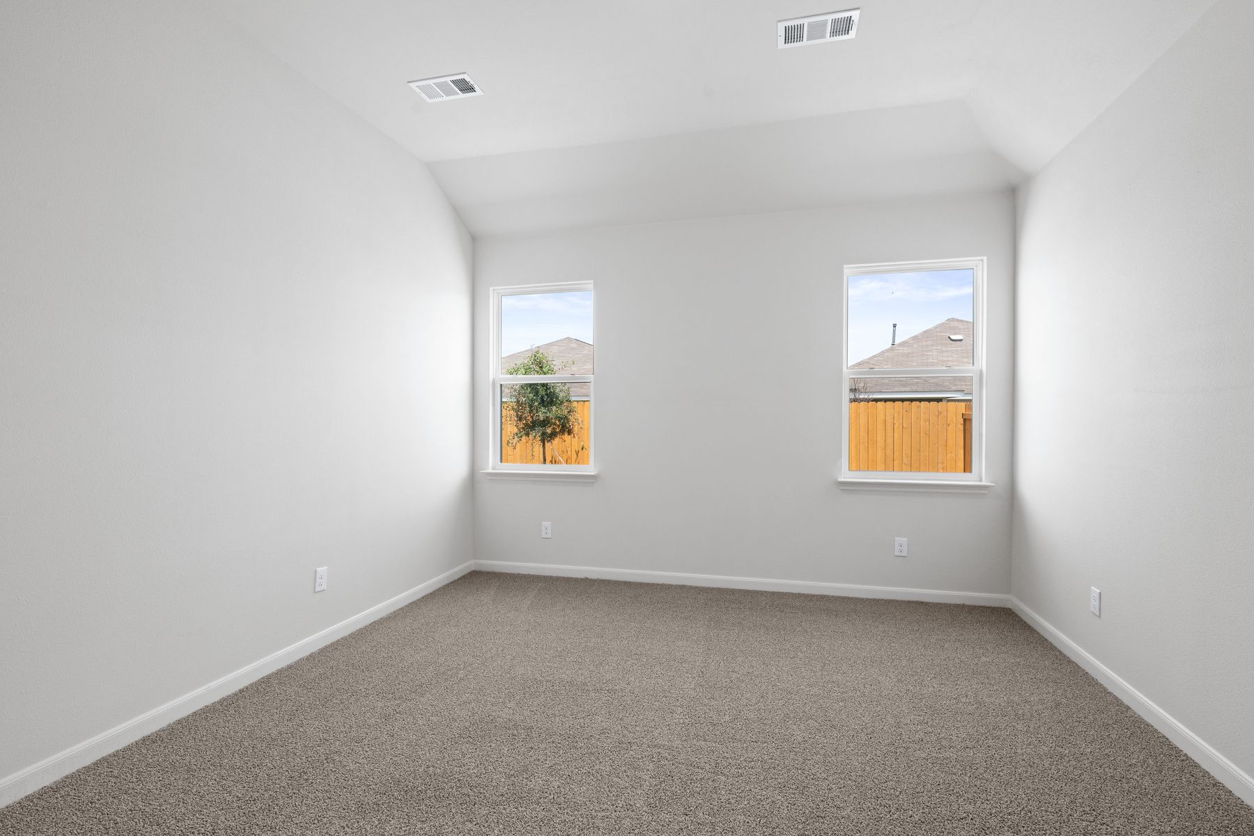 The master bedroom has two large windows.
