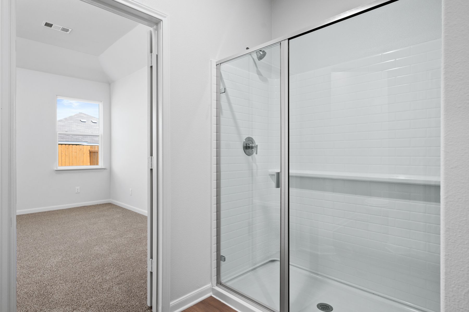 The master bathroom has a glass, walk-in shower.