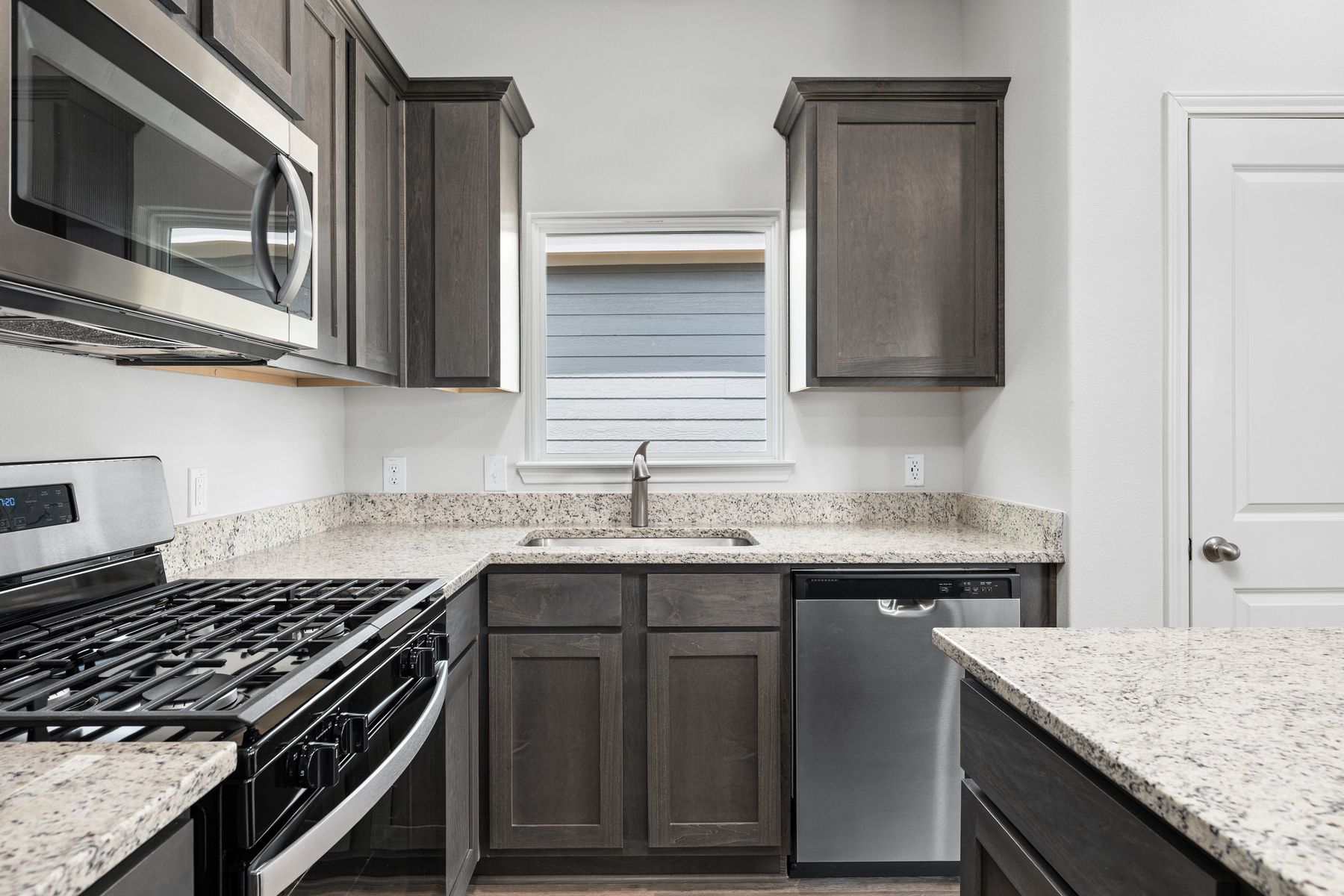 The kitchen of the Sabine has beautiful wood cabinetry.