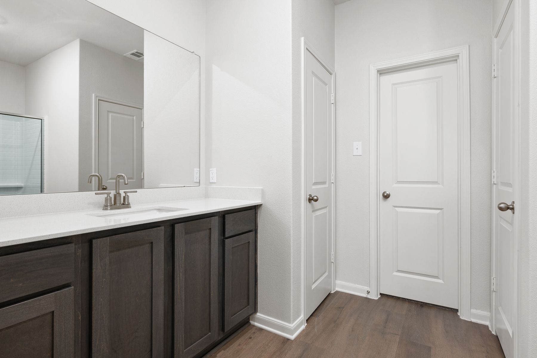 The master bathroom has a spacious vanity.
