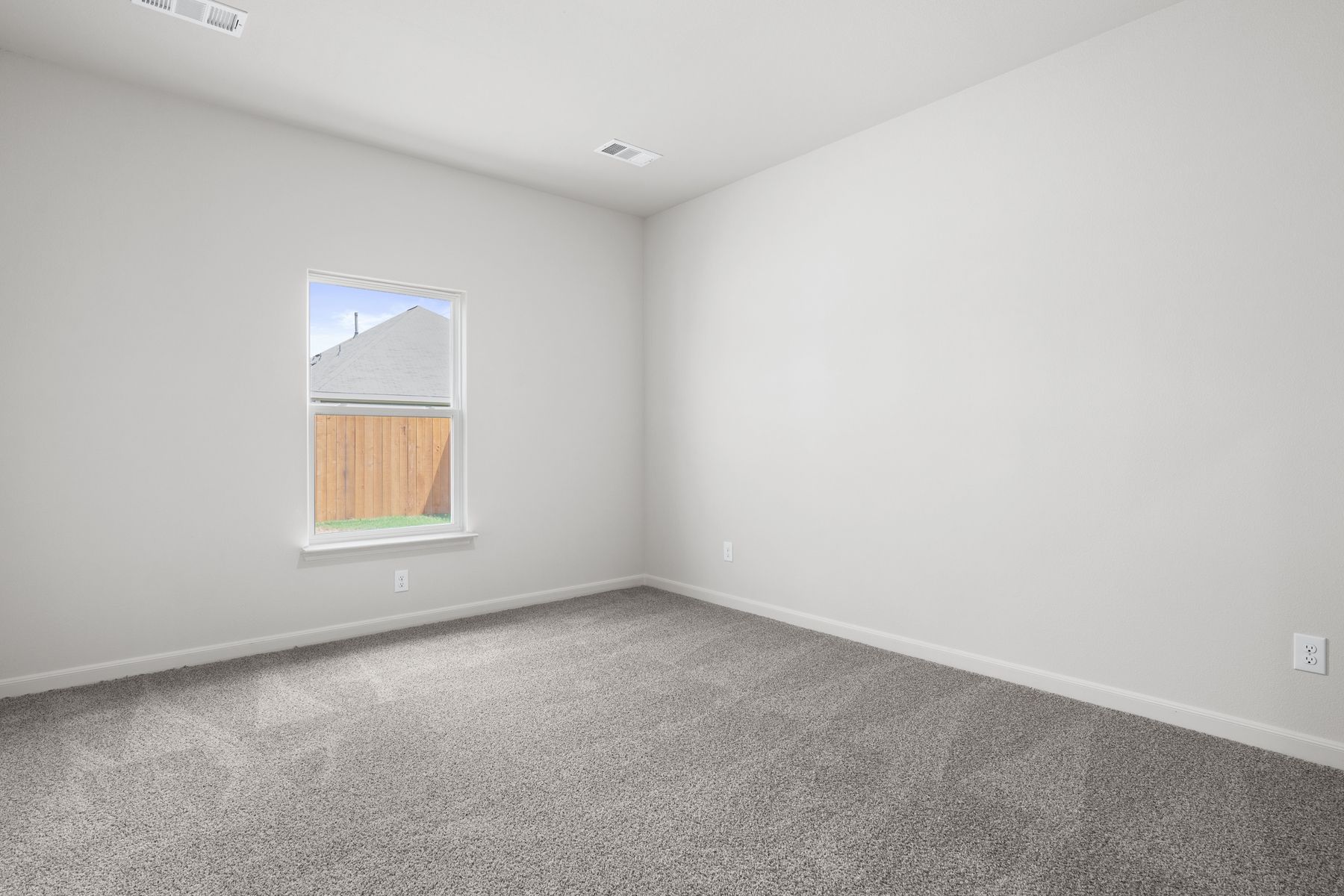 The master bedrooms is spacious and has a large window.
