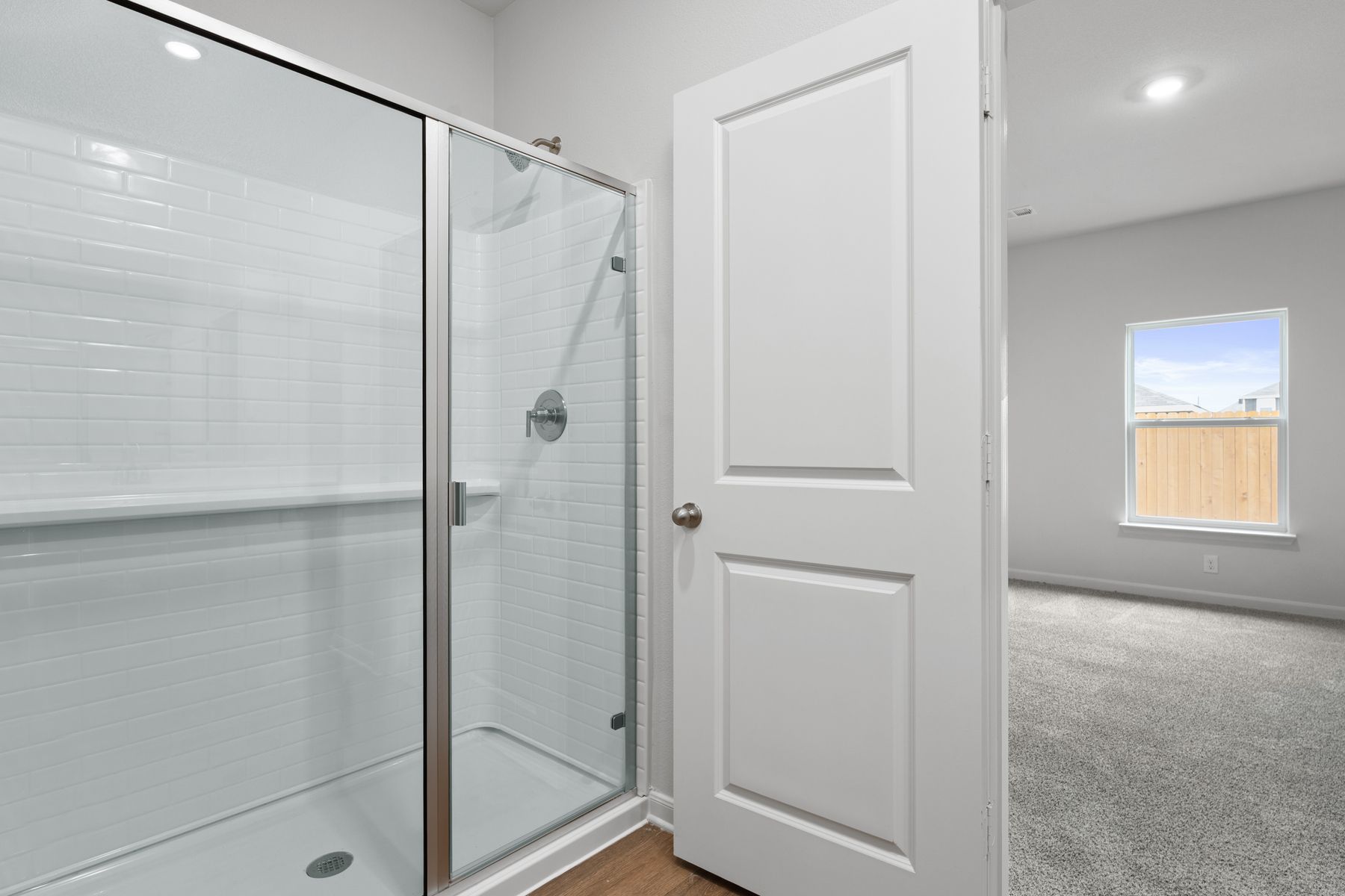 The master bathroom has a glass walk-in shower.