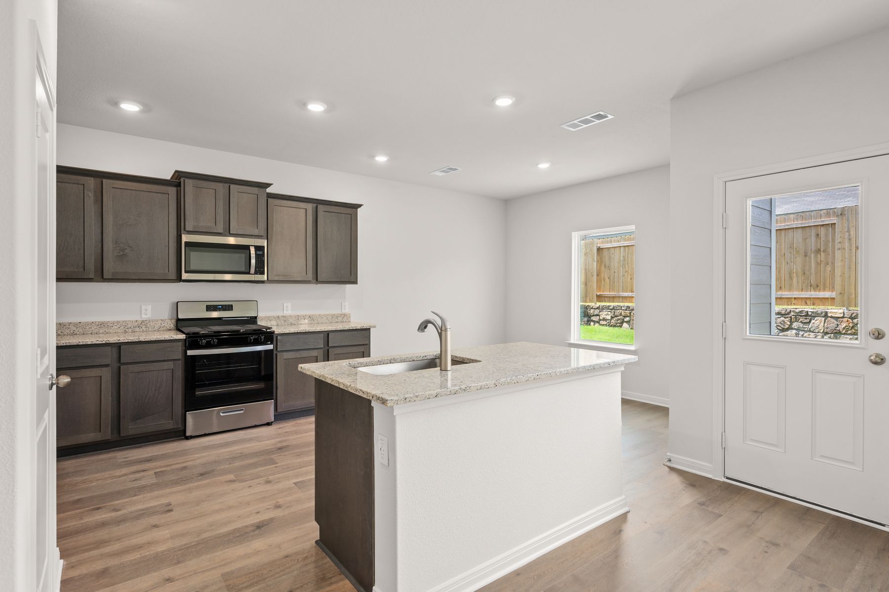 The kitchen has sprawling granite countertops.