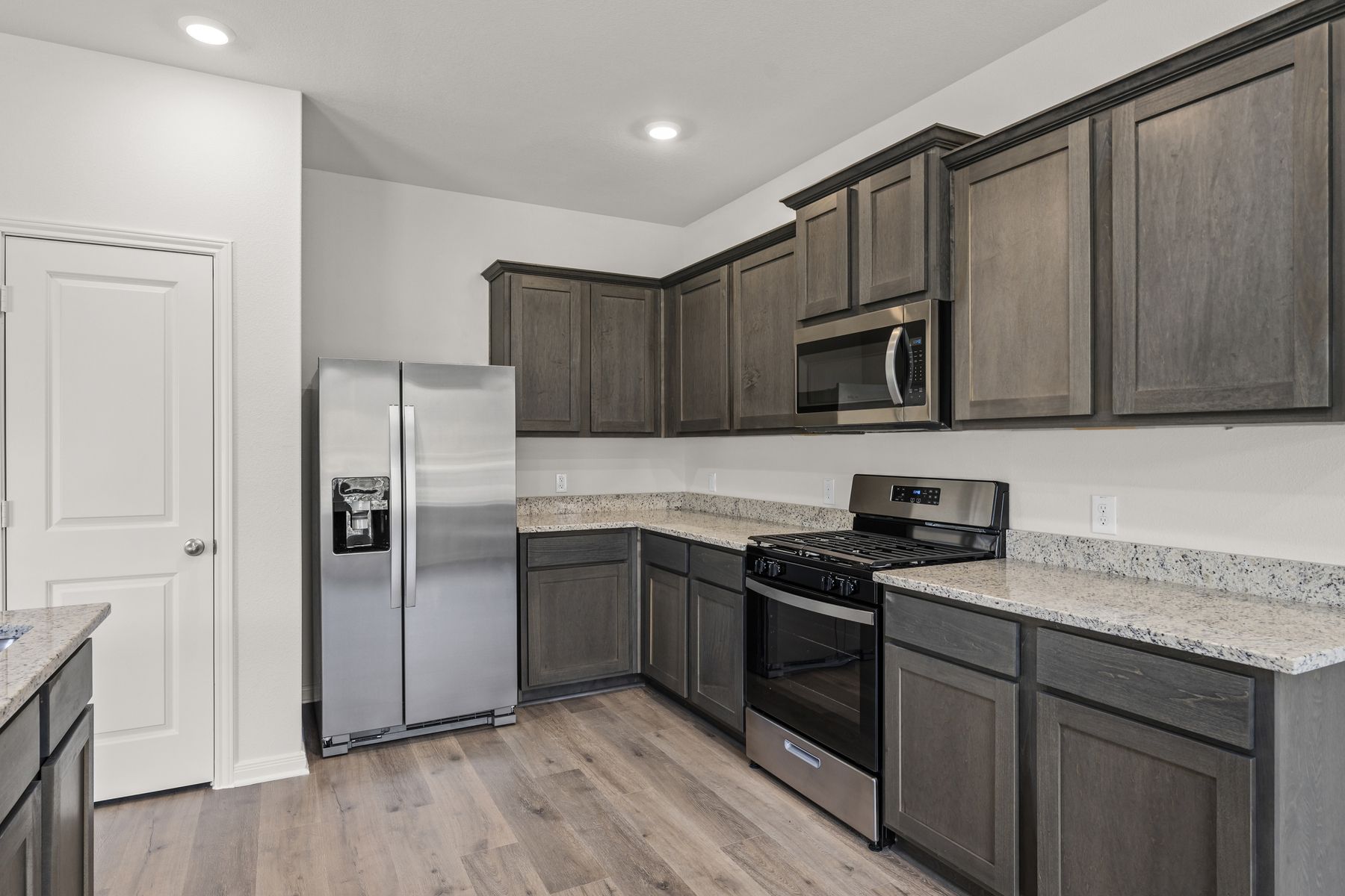 The kitchen has gorgeous wood cabinetry.