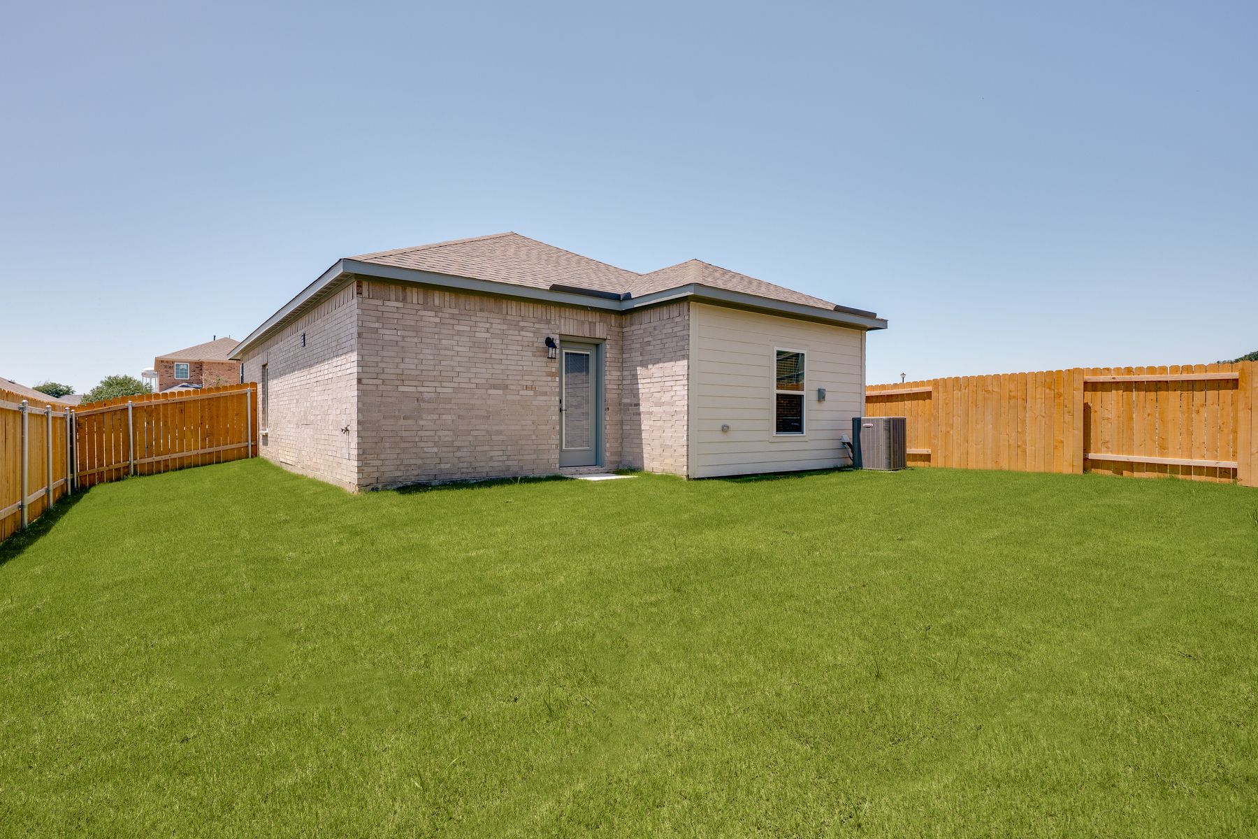 The back yard of the Alfalfa is fully fenced.