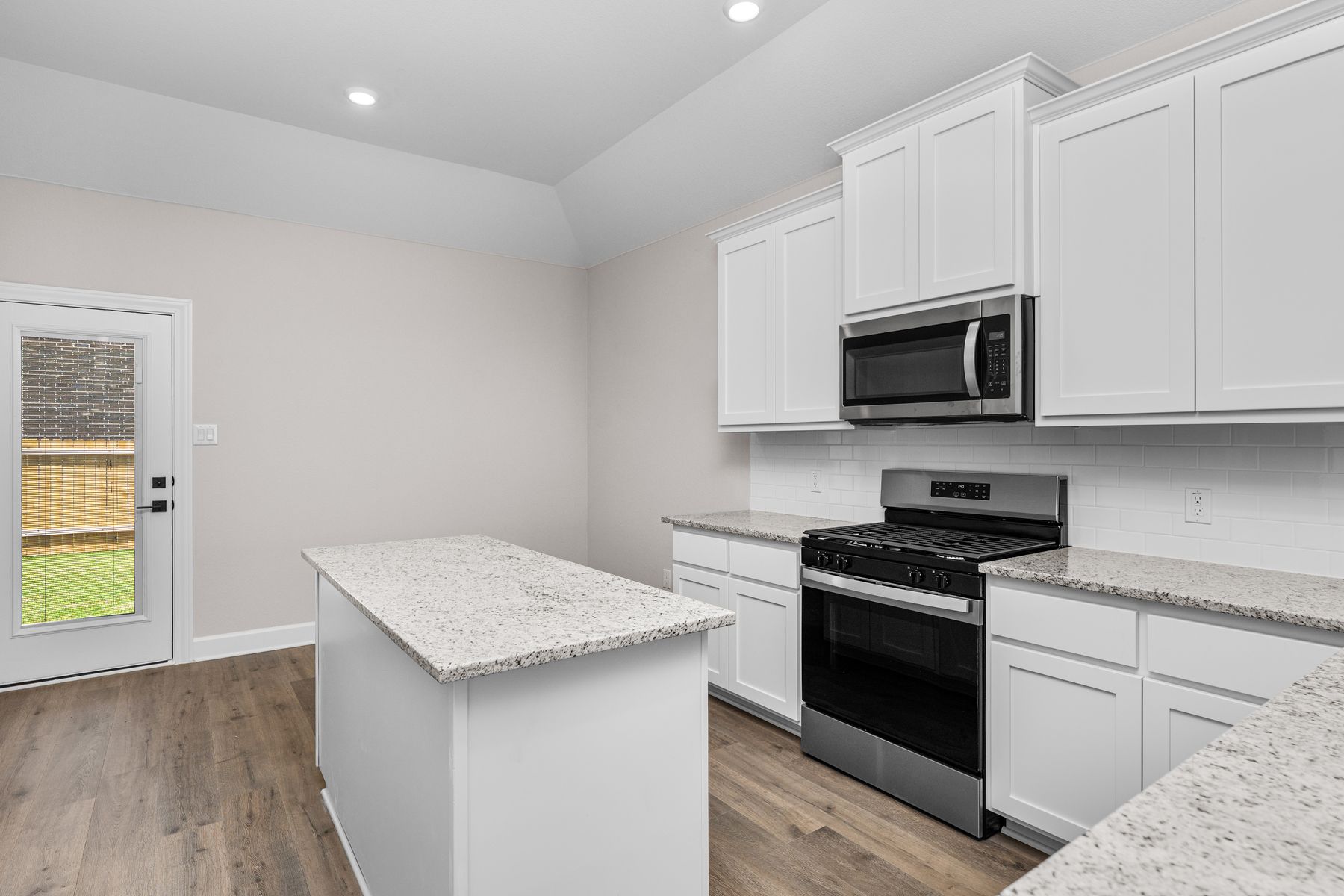The kitchen has sprawling granite countertops.