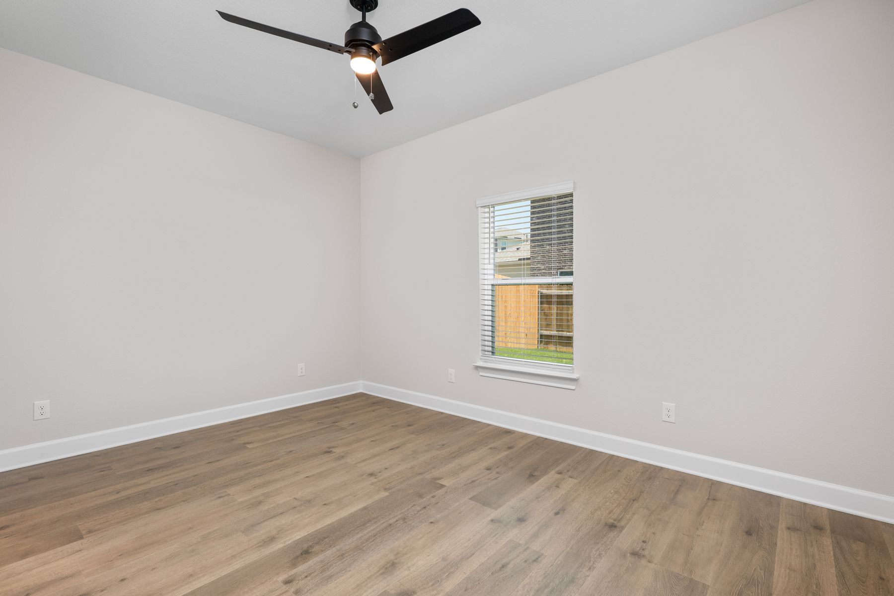 The master bedroom has a large window that lets in natural light.