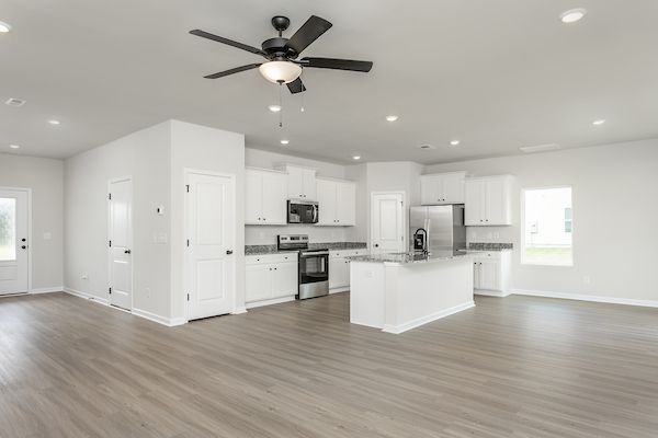 The kitchen has designer wood cabinetry