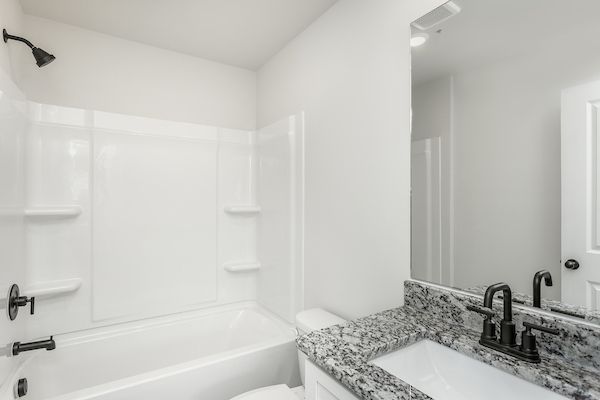 The secondary bathroom has a large soaking tub. 