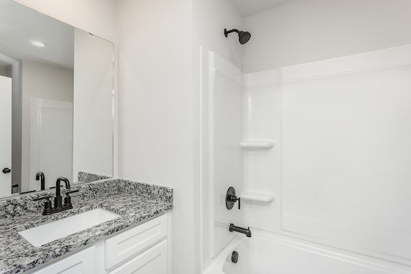 The secondary bathroom has a large soaking tub