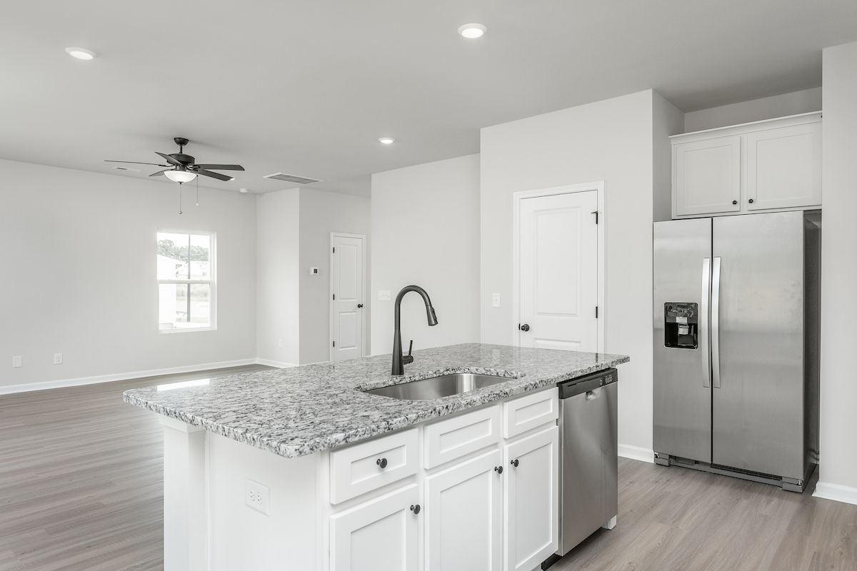 The kitchen has a granite island. 