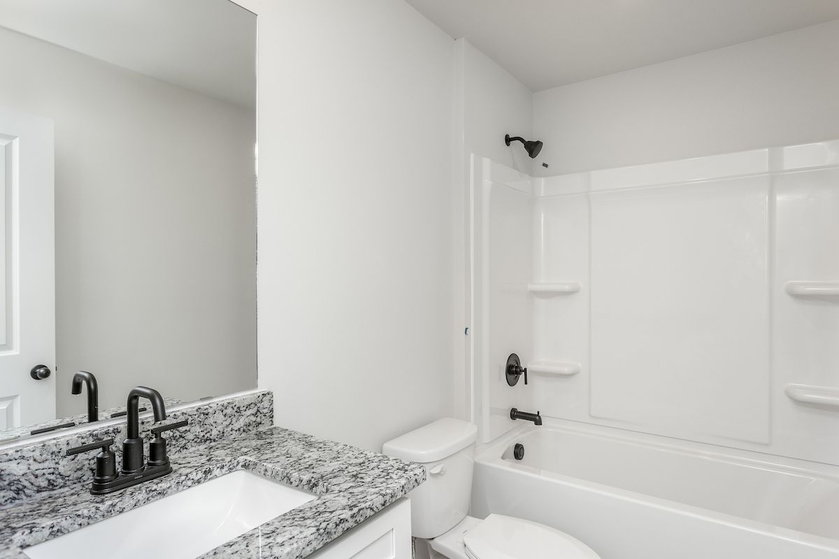 The secondary bathroom has a large soaking tub. 