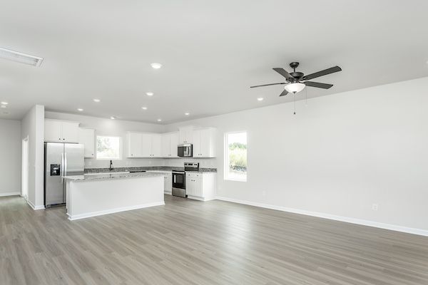 The kitchen has designer wood cabinetry