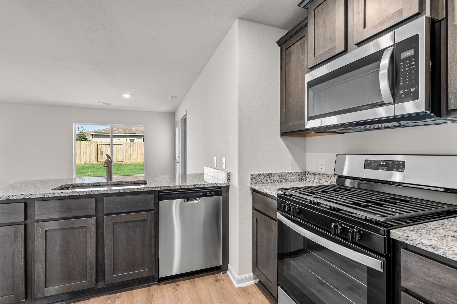 The kitchen looks out into the dining room.