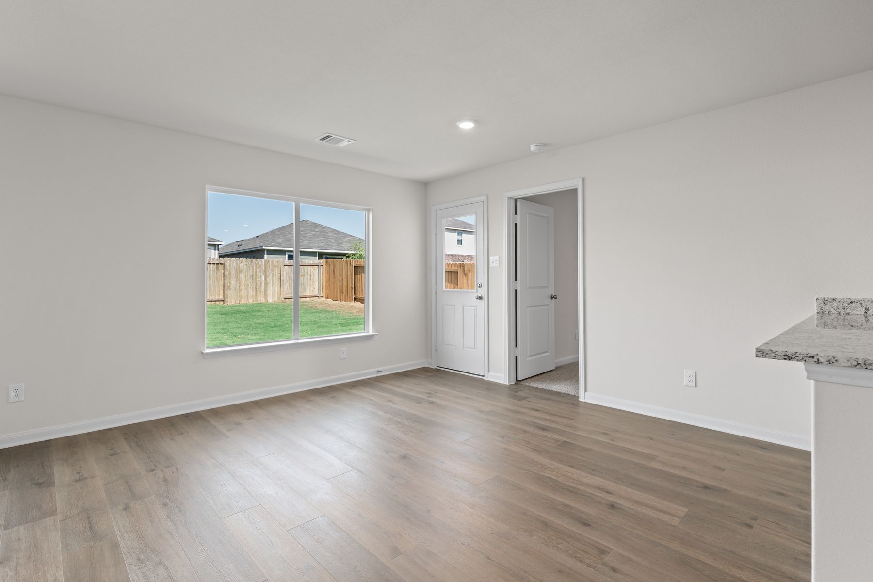 The dining room sits right off of the kitchen and has a large window.