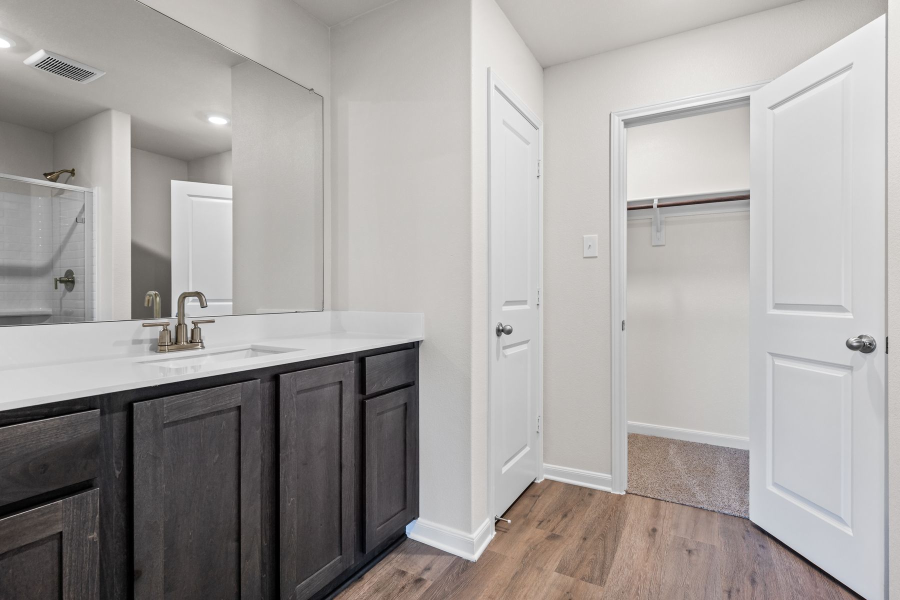 The master bathroom has a sprawling quartz vanity.