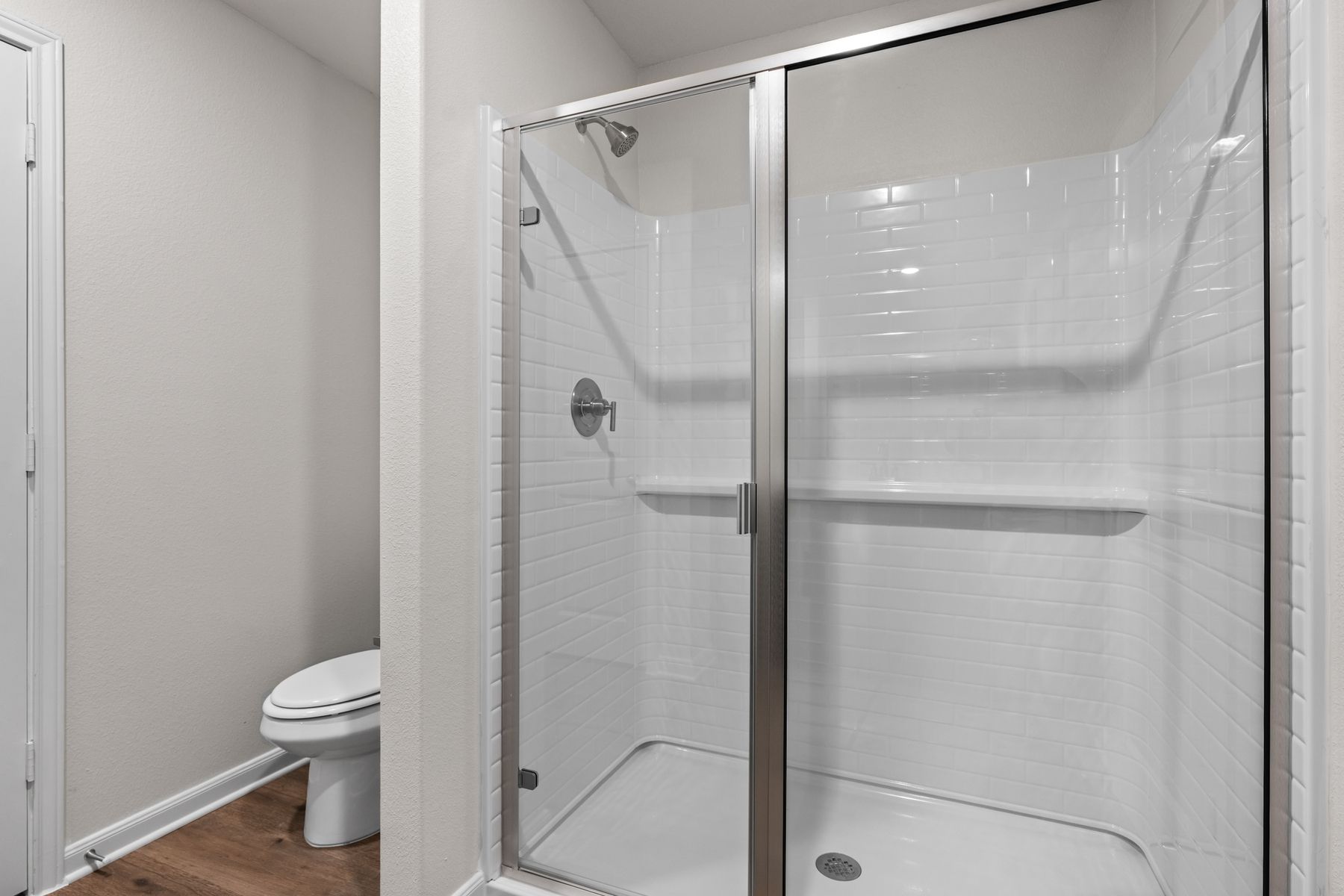 The master bathroom has a walk-in, glass shower.