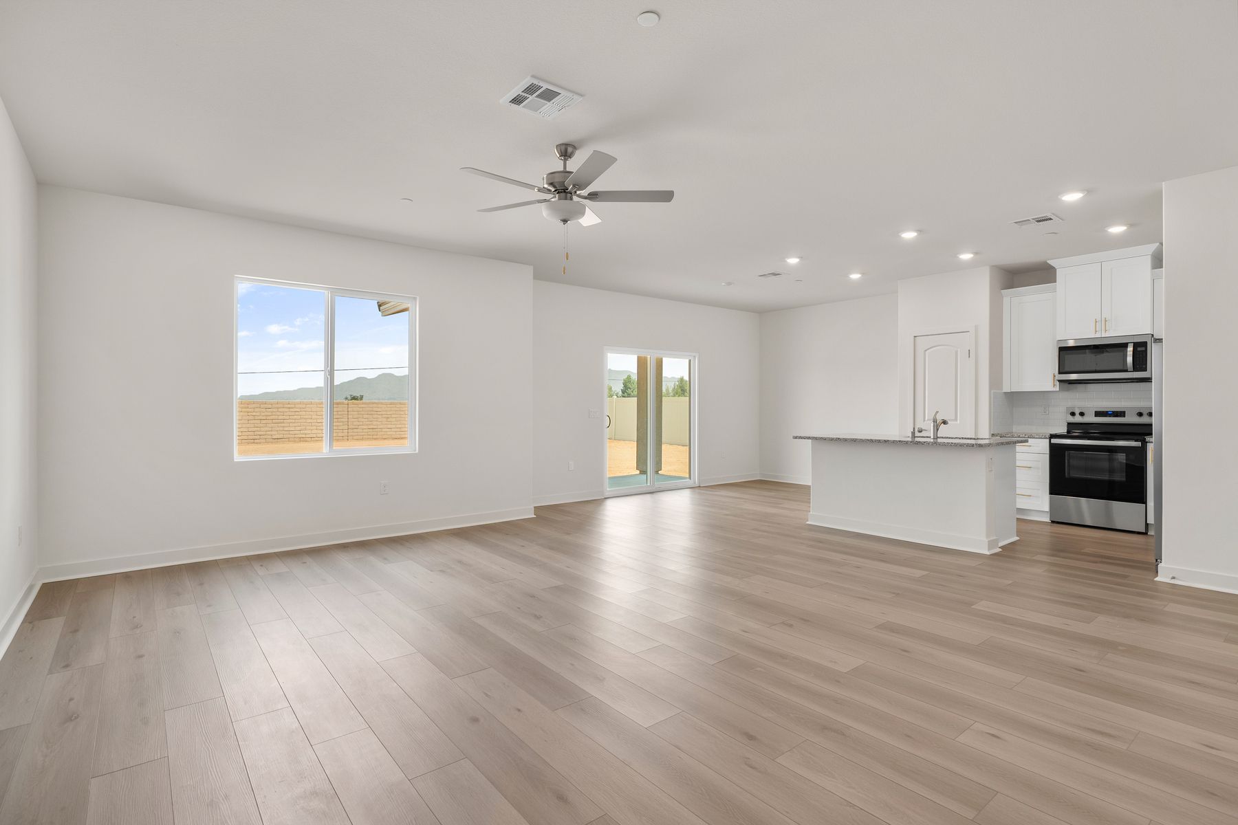 The family room is spacious with a ceiling fan.