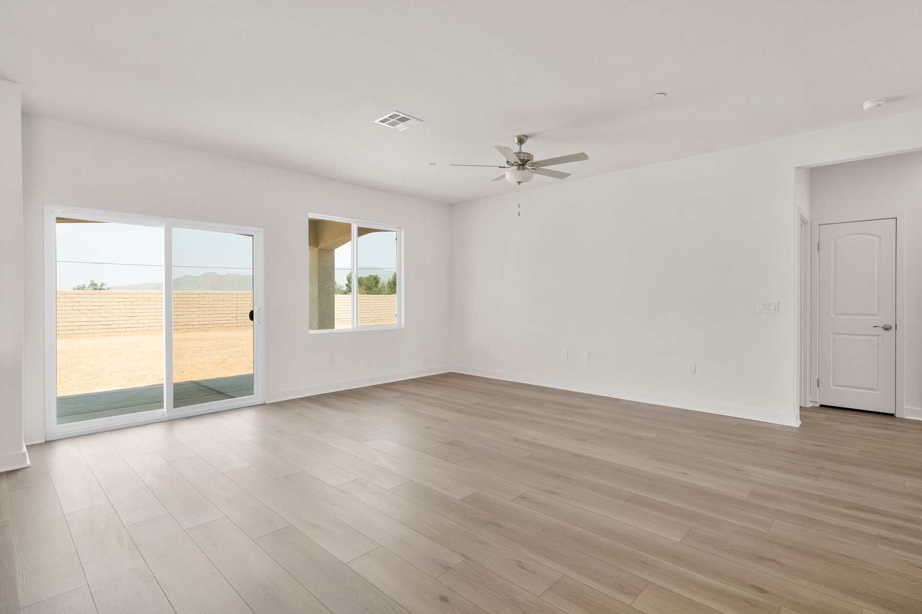The family room is spacious with a ceiling fan.
