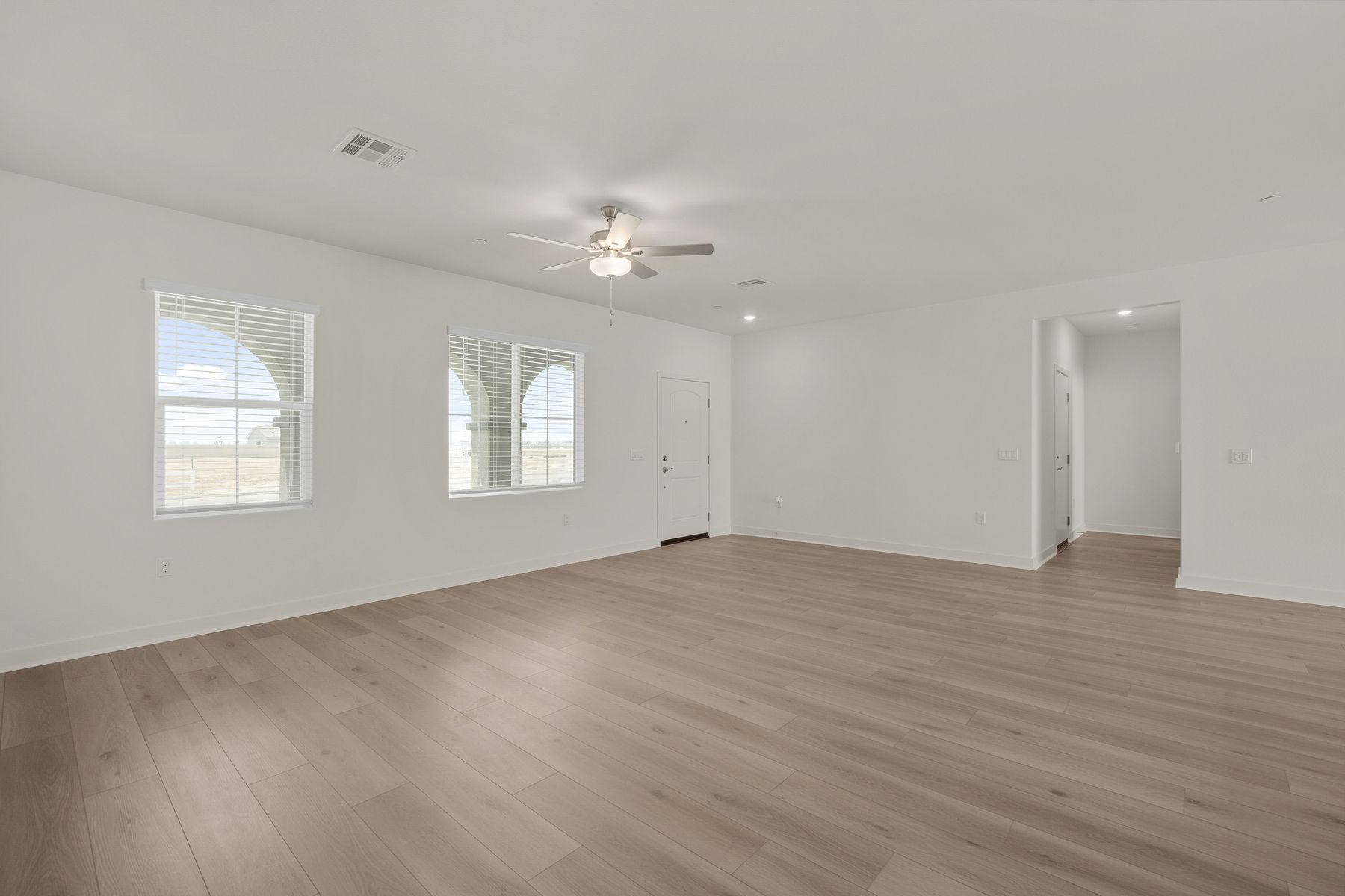 The family room is spacious with a ceiling fan.